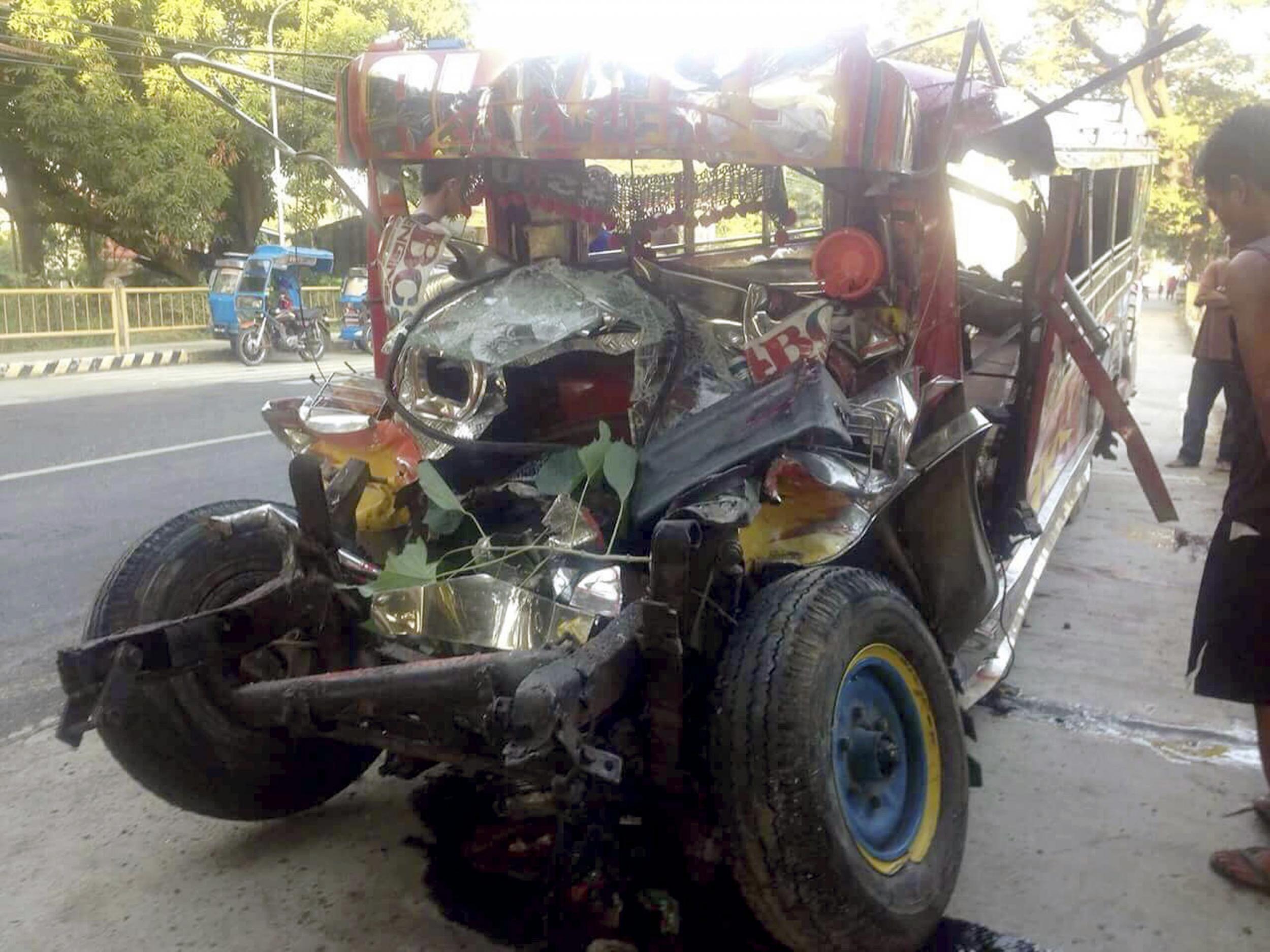 The wreckage of a passenger van in La Union province