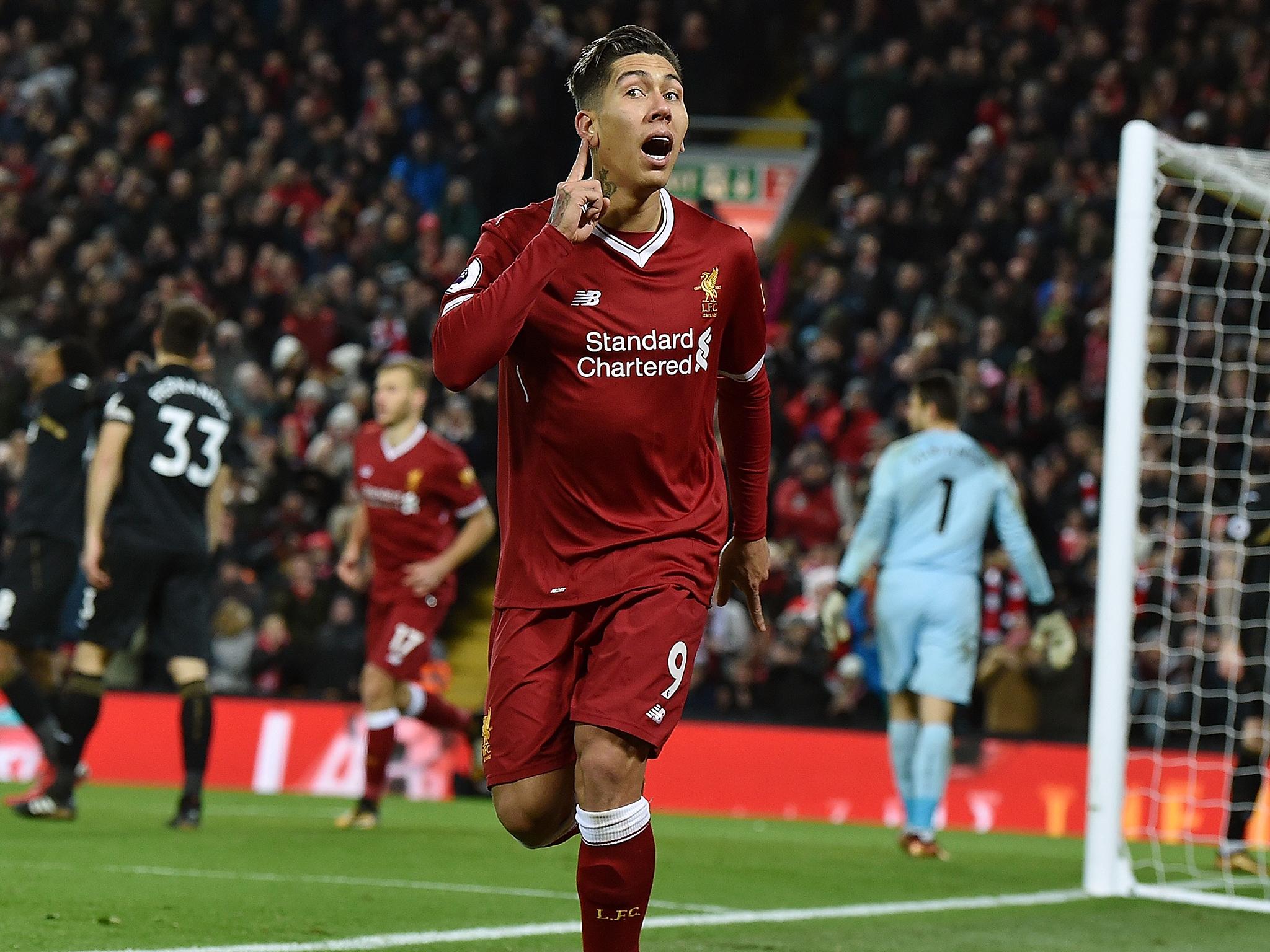 Roberto Firmino celebrates scoring Liverpool's second goal against Swansea