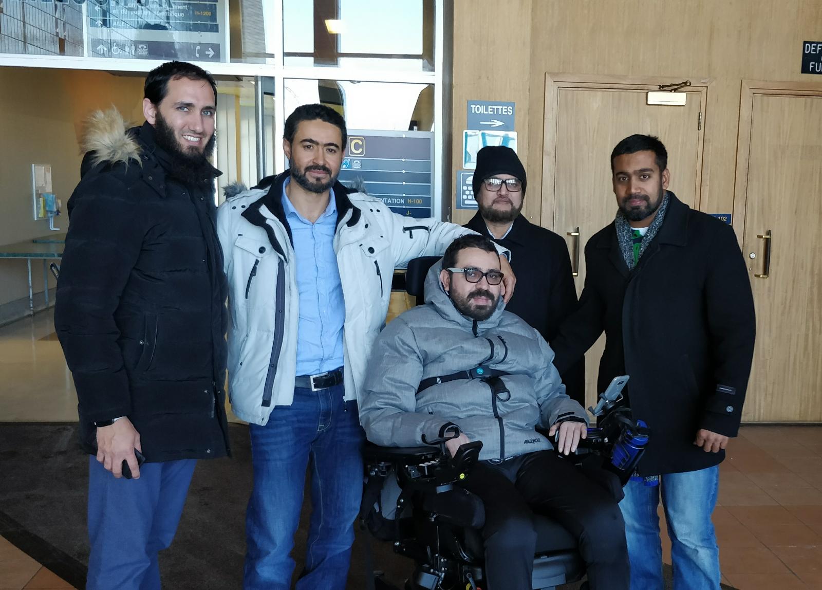 Aymen Derbali (centre) has lost the use of his legs after being shot seven times