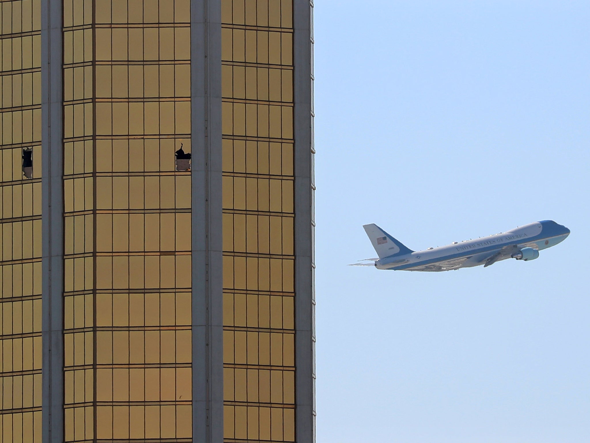 Air Force One departs Las Vegas past the broken windows on the Mandalay Bay hotel, where shooter Stephen Paddock conducted his mass shooting