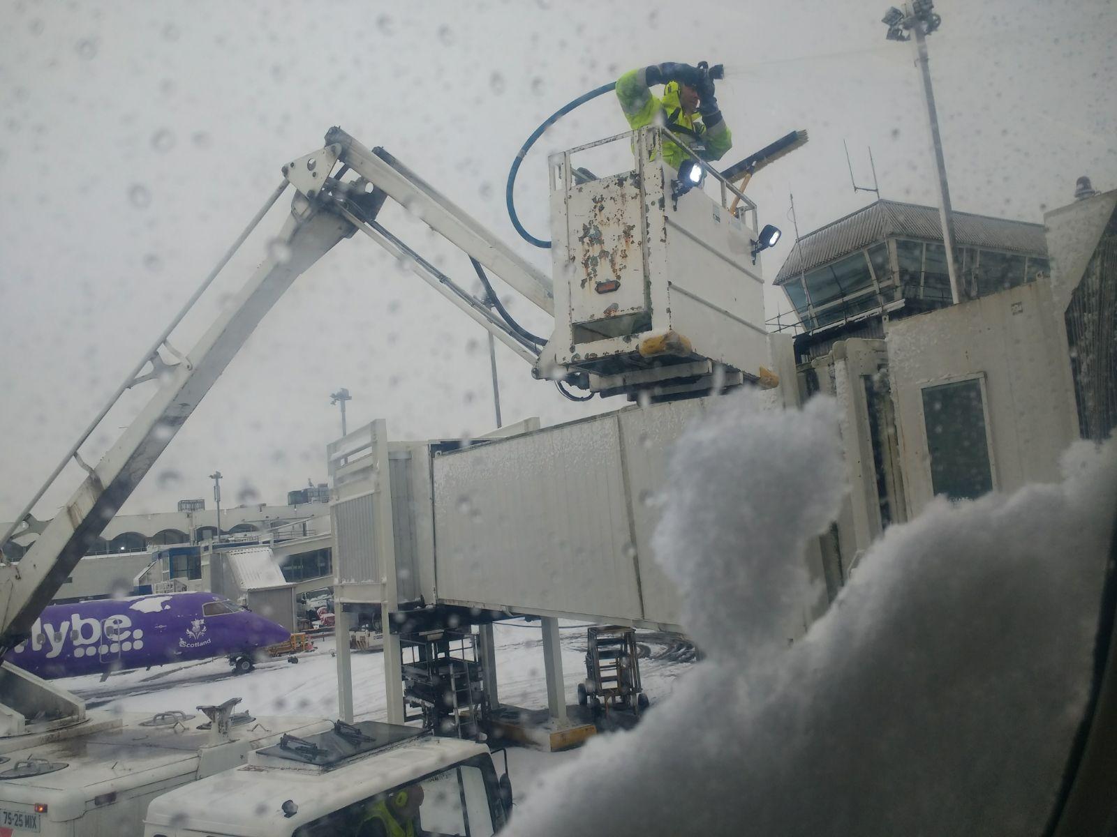 Workers de-icing a plane at Glasgow Airport