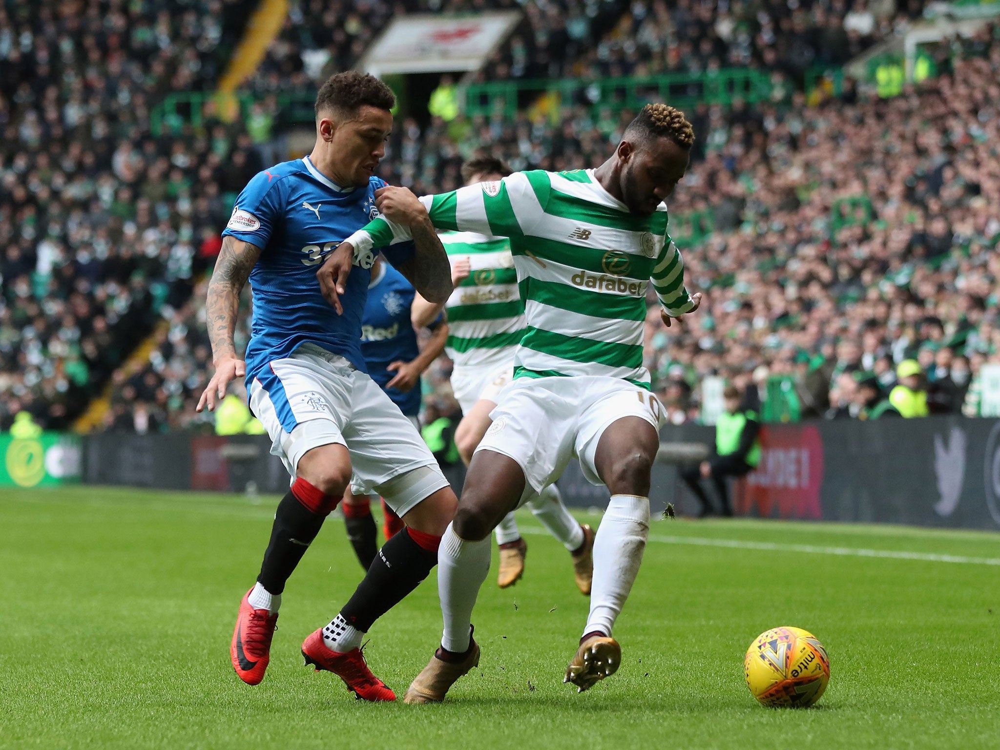 Moussa Dembele is challenged by James Tavernier