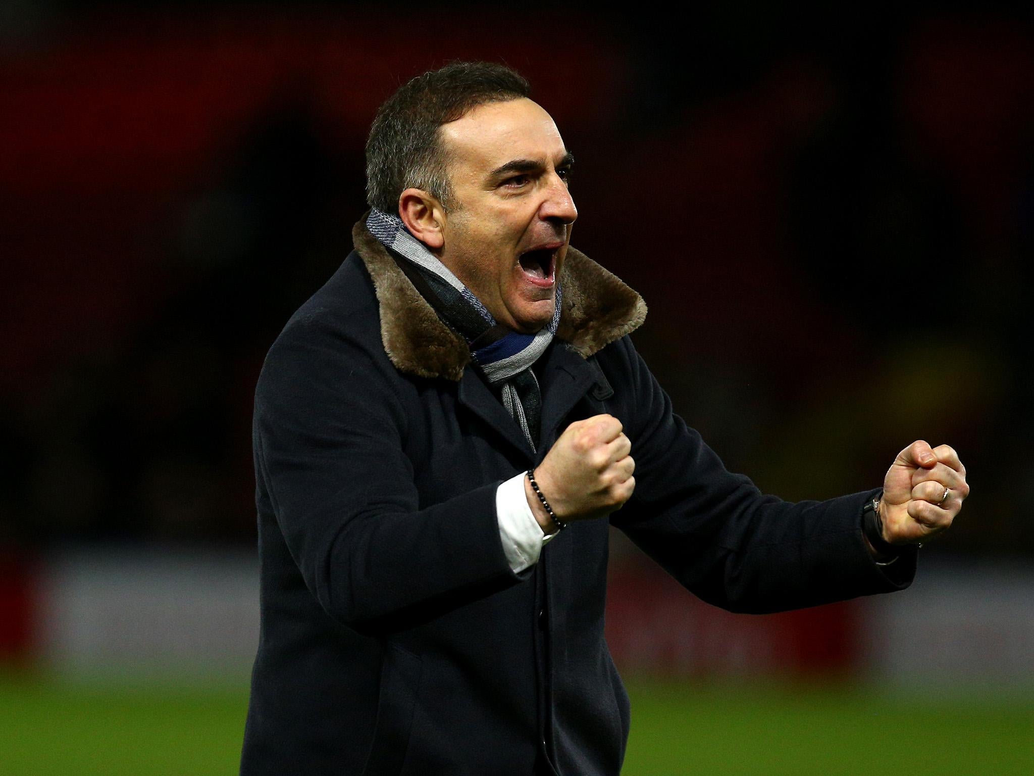 The Swansea boss celebrates after the final whistle at Vicarage Road