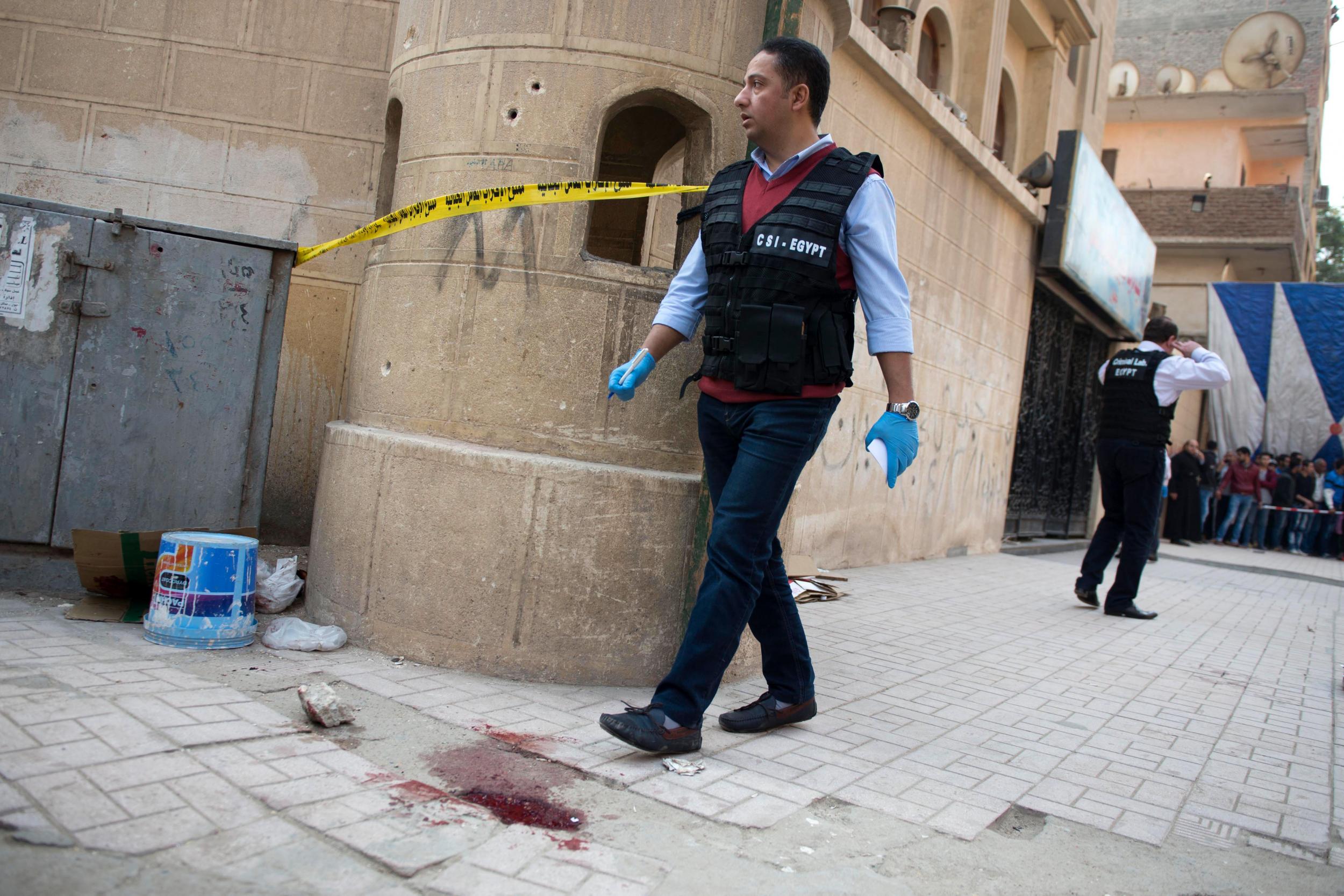 Security officials outside Mar Mina church following the attack