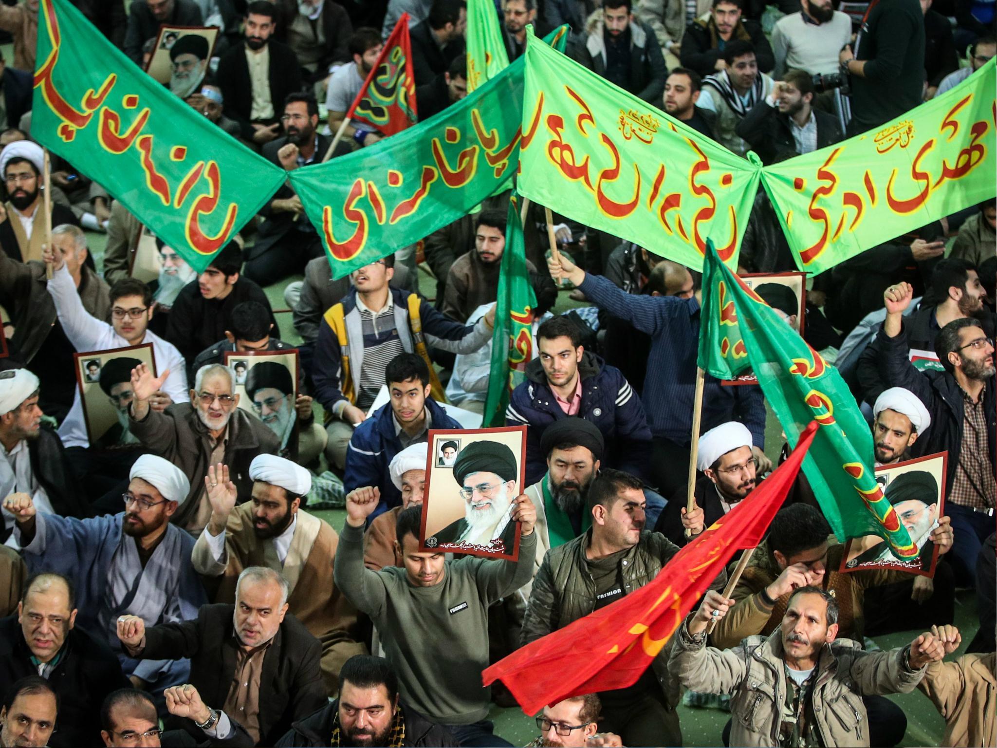 Iranians chant slogans as they march in support of the government near the Imam Khomeini grand mosque in the capital Tehran on 30 December 2017 (HAMED MALEKPOUR/AFP/Getty Images)