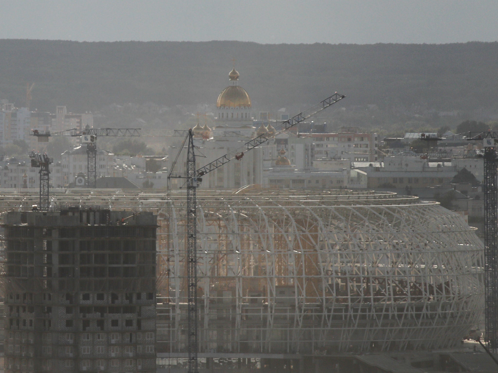 The Mordovia Arena stadium under construction, with the Mordovian State University building behind it