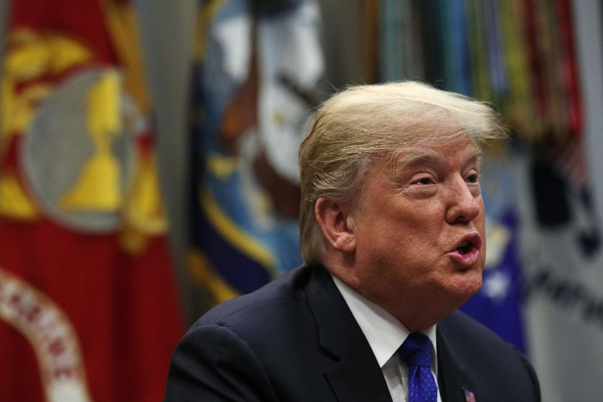 President Donald Trump speaks during a meeting in the Roosevelt Room of the White House