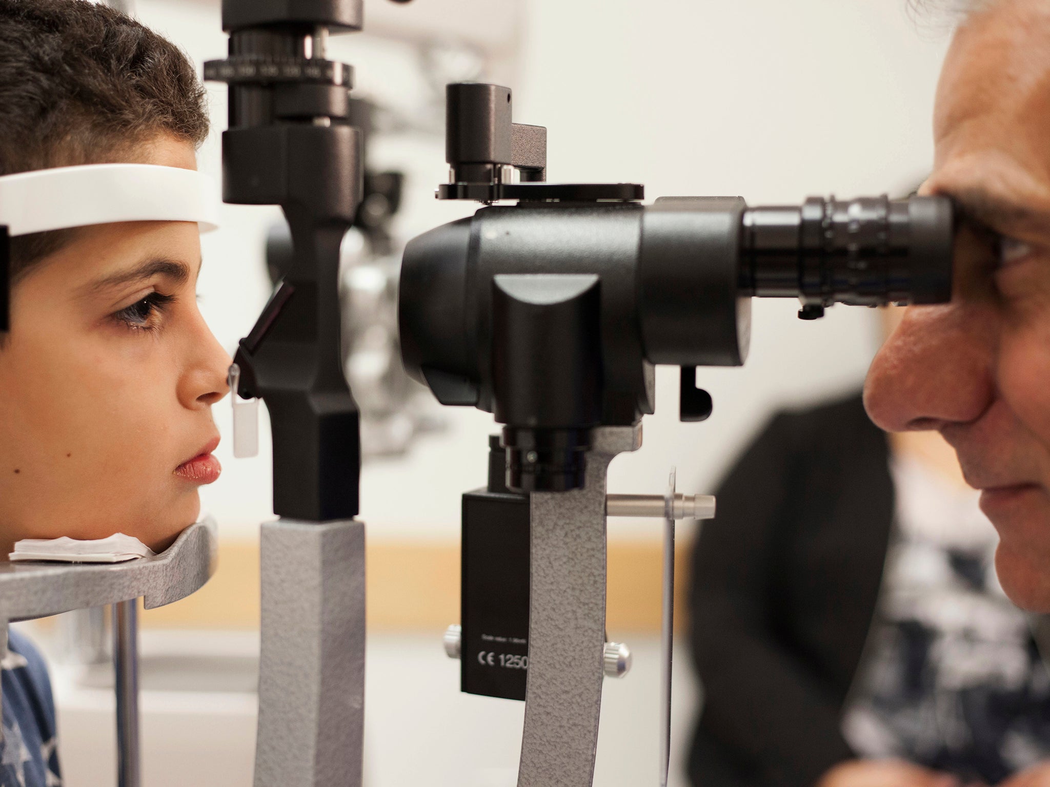 Dr. Albert Maguire, right, checks the eyes of Misa Kaabali, 8, at the Children's Hospital of Philadelphia. Misa was 4-years-old when he received his gene therapy treatment.