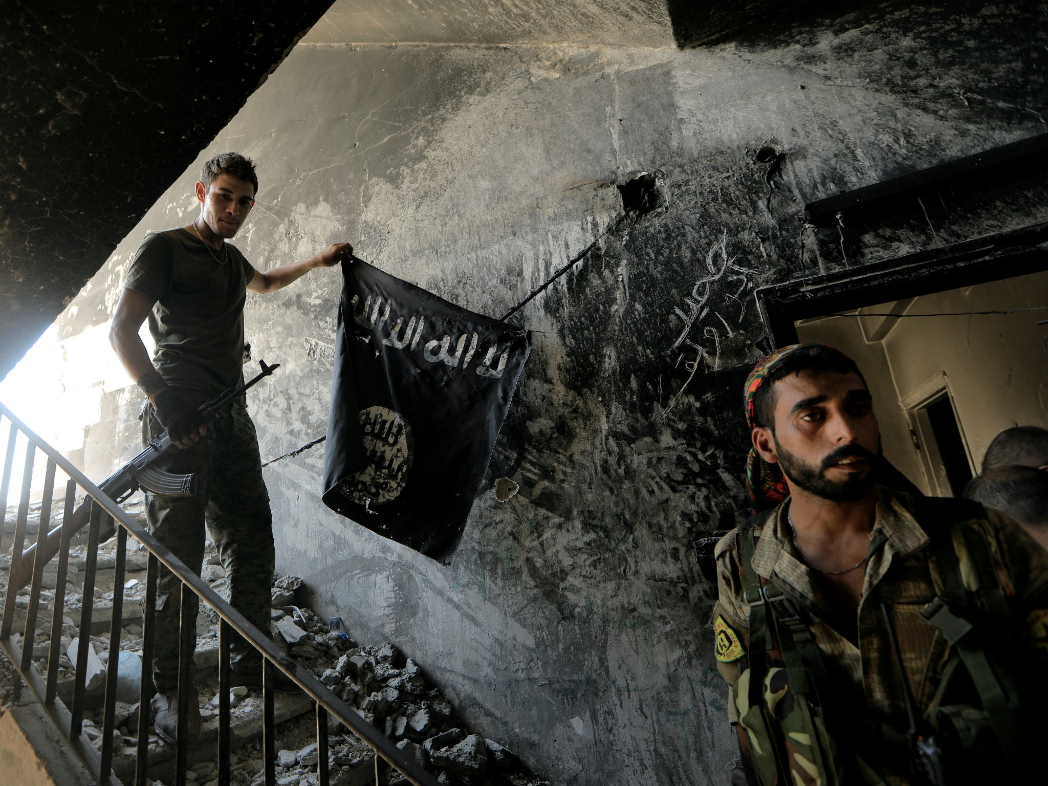 Members of the Syrian Democratic Forces, which picked up an American citizen who's been held for months in Iraq