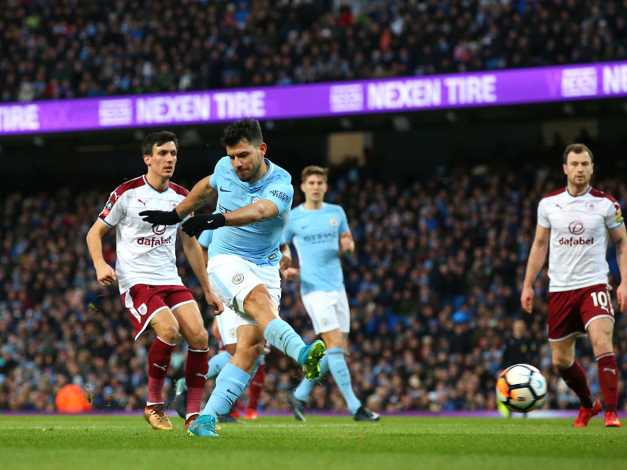 Sergio Aguero scores the first of his two goals against Burnley (Getty )