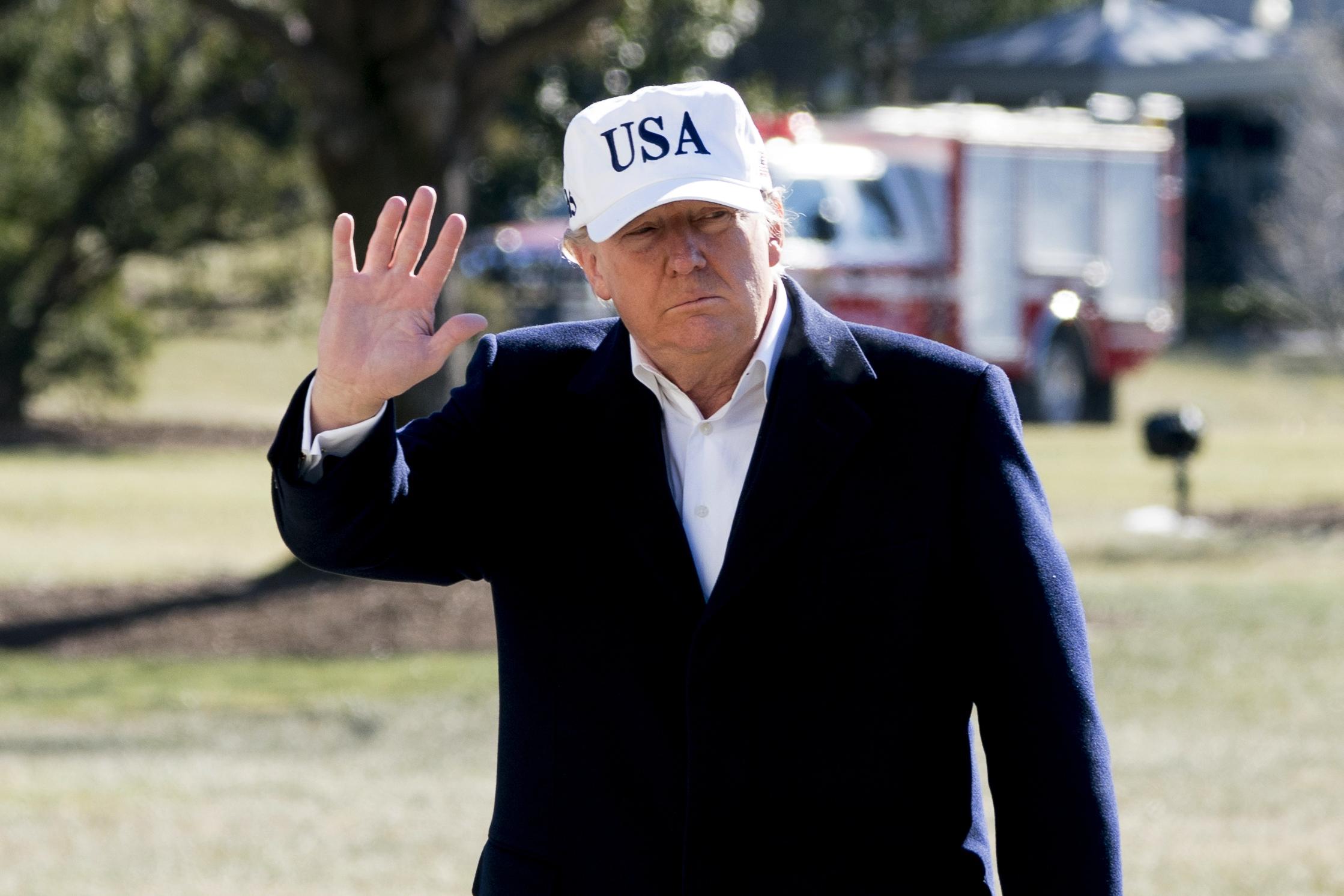 President Trump waves to the media as he walks across the White House’s South Lawn