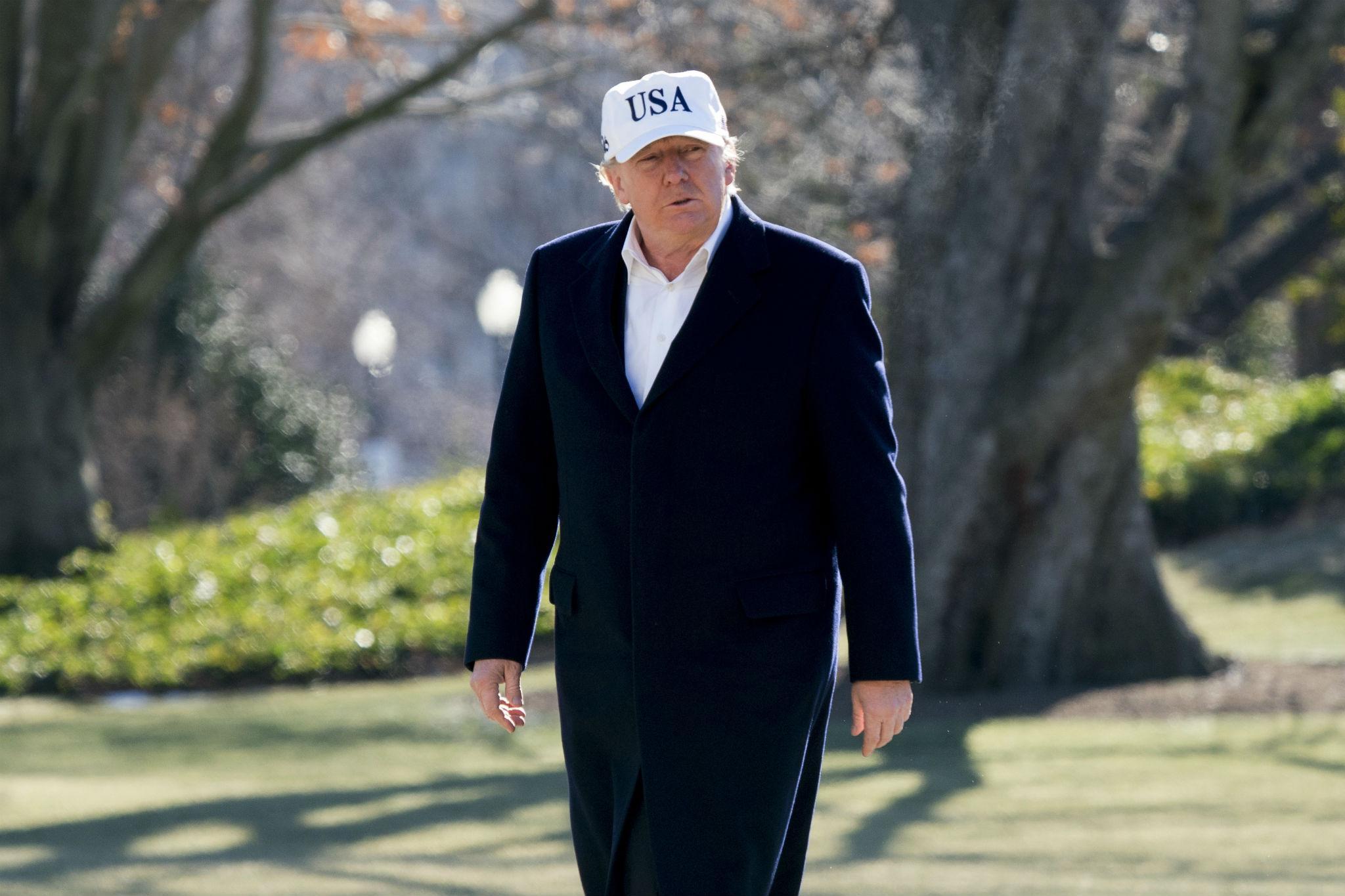 President Donald Trump walks across the South Lawn as he arrives at the White House in Washington