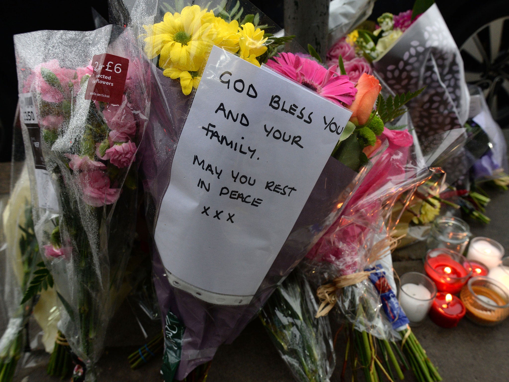 &#13;
Tributes outside the shop on The Broadway in Mill Hill, north London &#13;