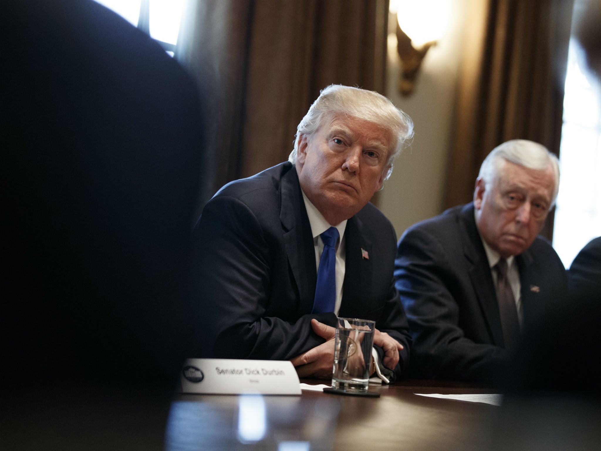 Donald Trump listens during a meeting with lawmakers on immigration policy in the White House