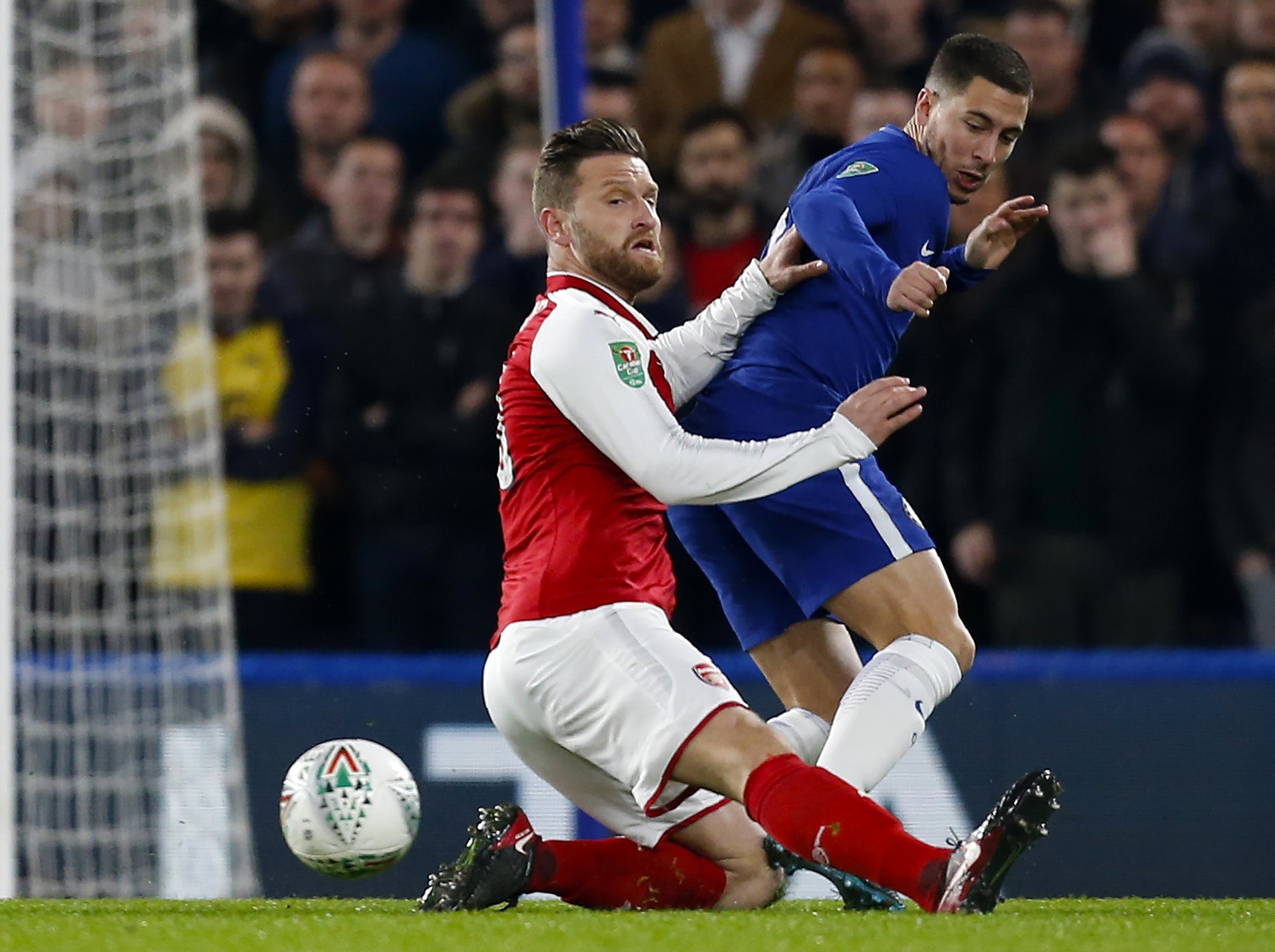 Eden Hazard is challenged by Shkodran Mustafi