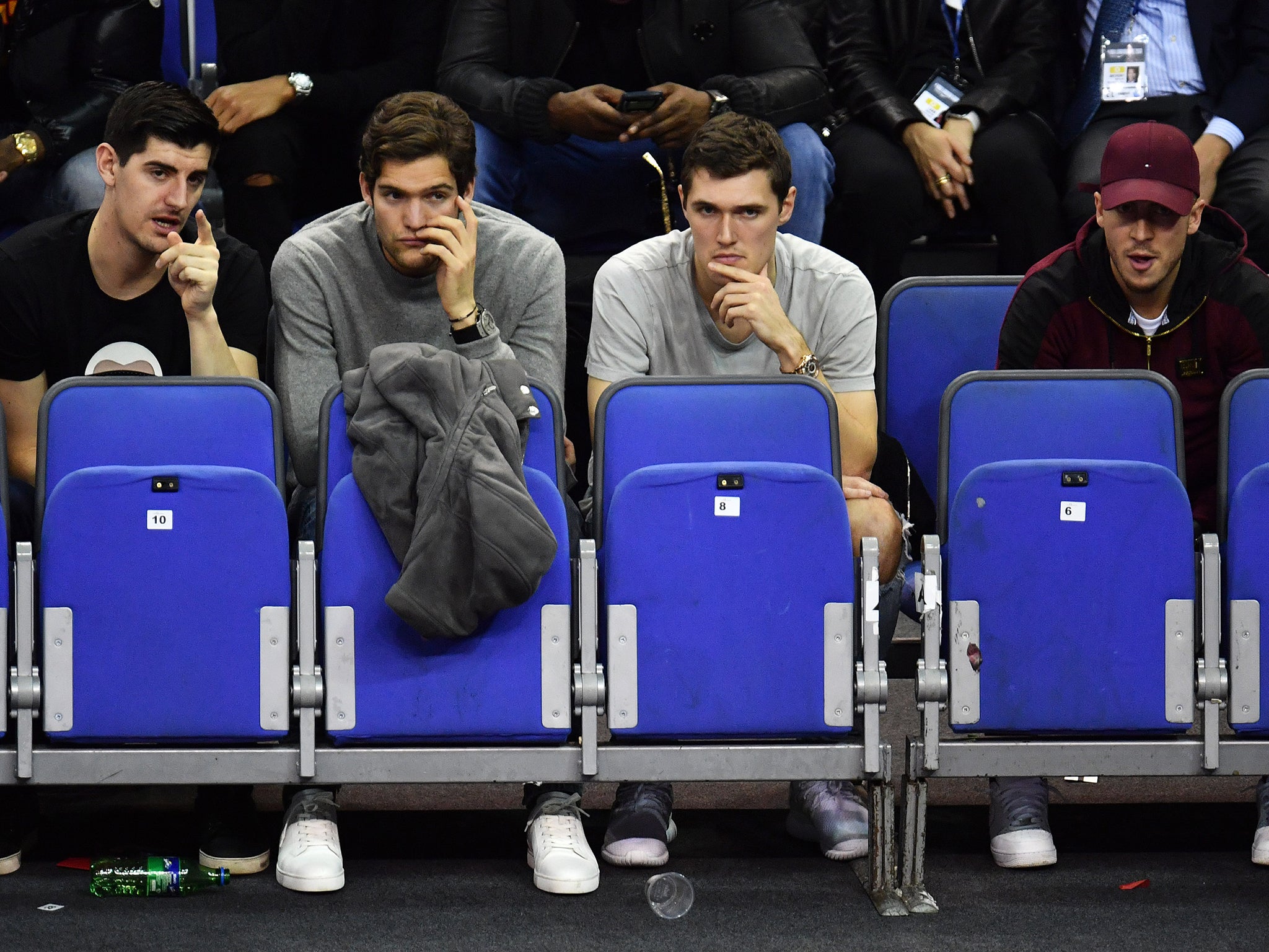 Hazard and Courtois sit with Chelsea teammates Marcos Alonso and Andreas Christensen