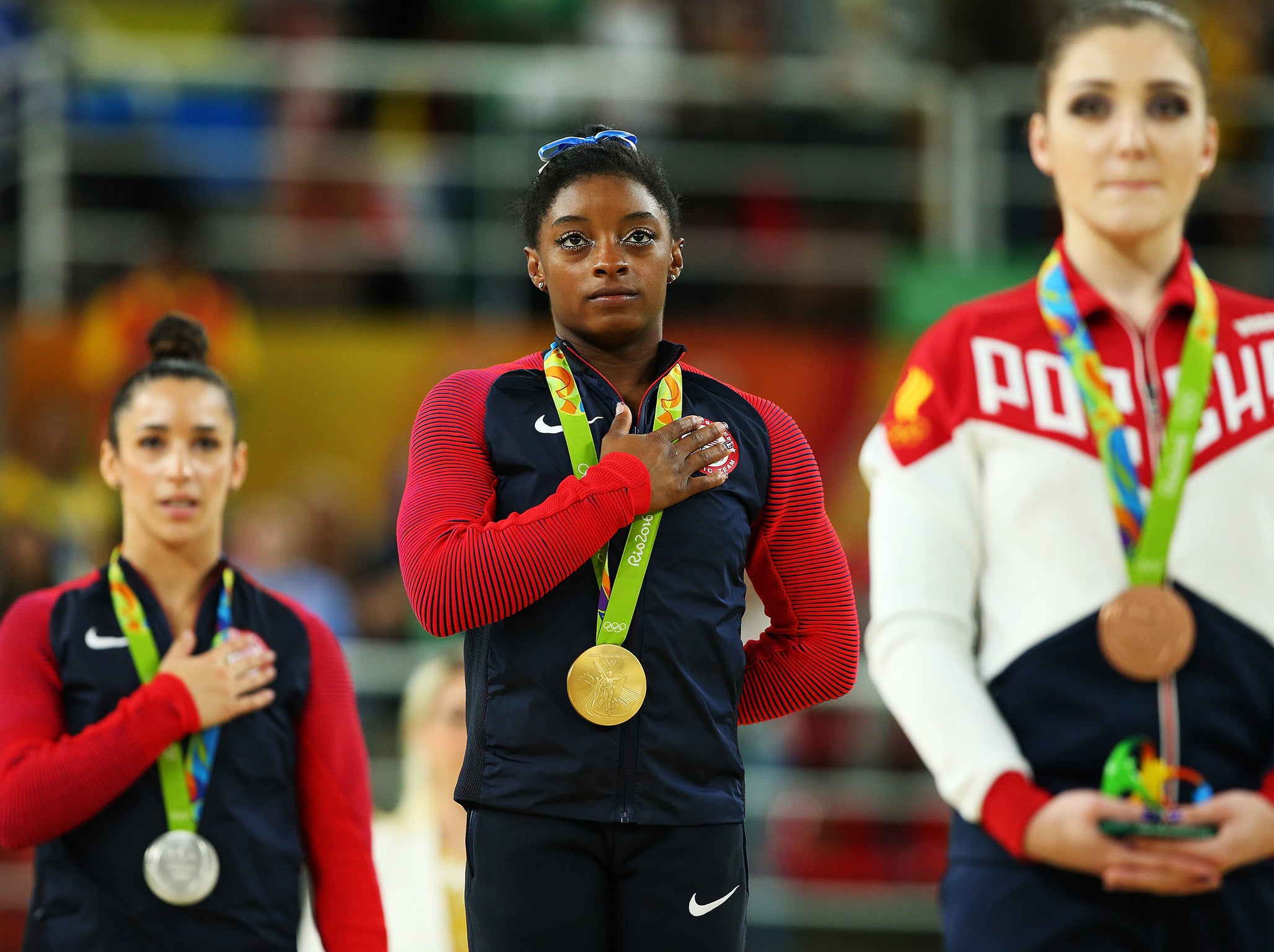 Simone Biles, centre, follows Aly Raisman, left, in accusing Larry Nassar of sexual abuse