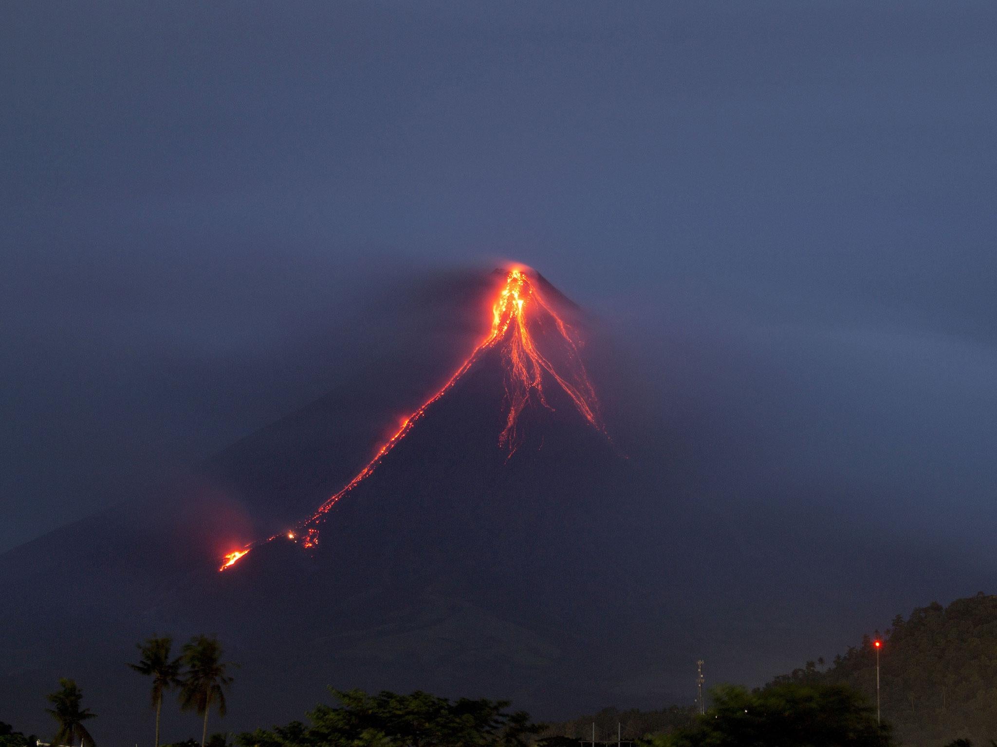 Lava continues to cascade down the slopes of the Mount Mayon volcano