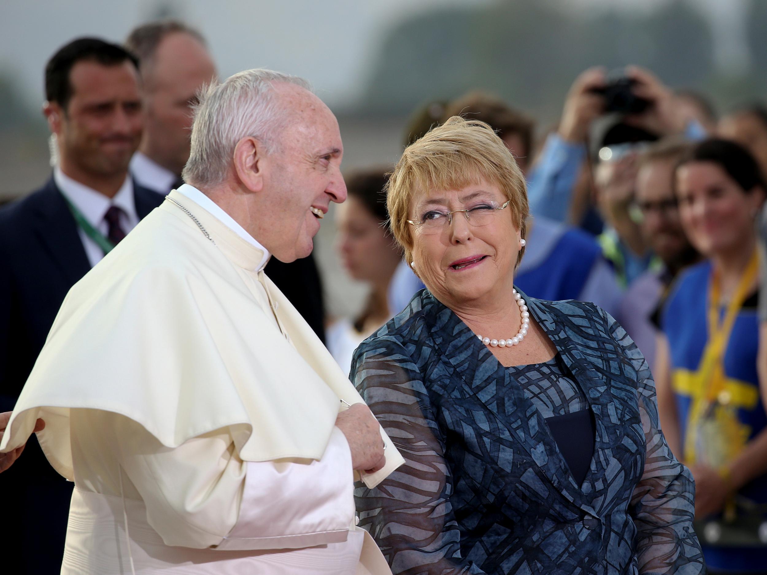 Pope Francis is greeted by Chile's President Michelle Bachelet upon his arrival in Santiago