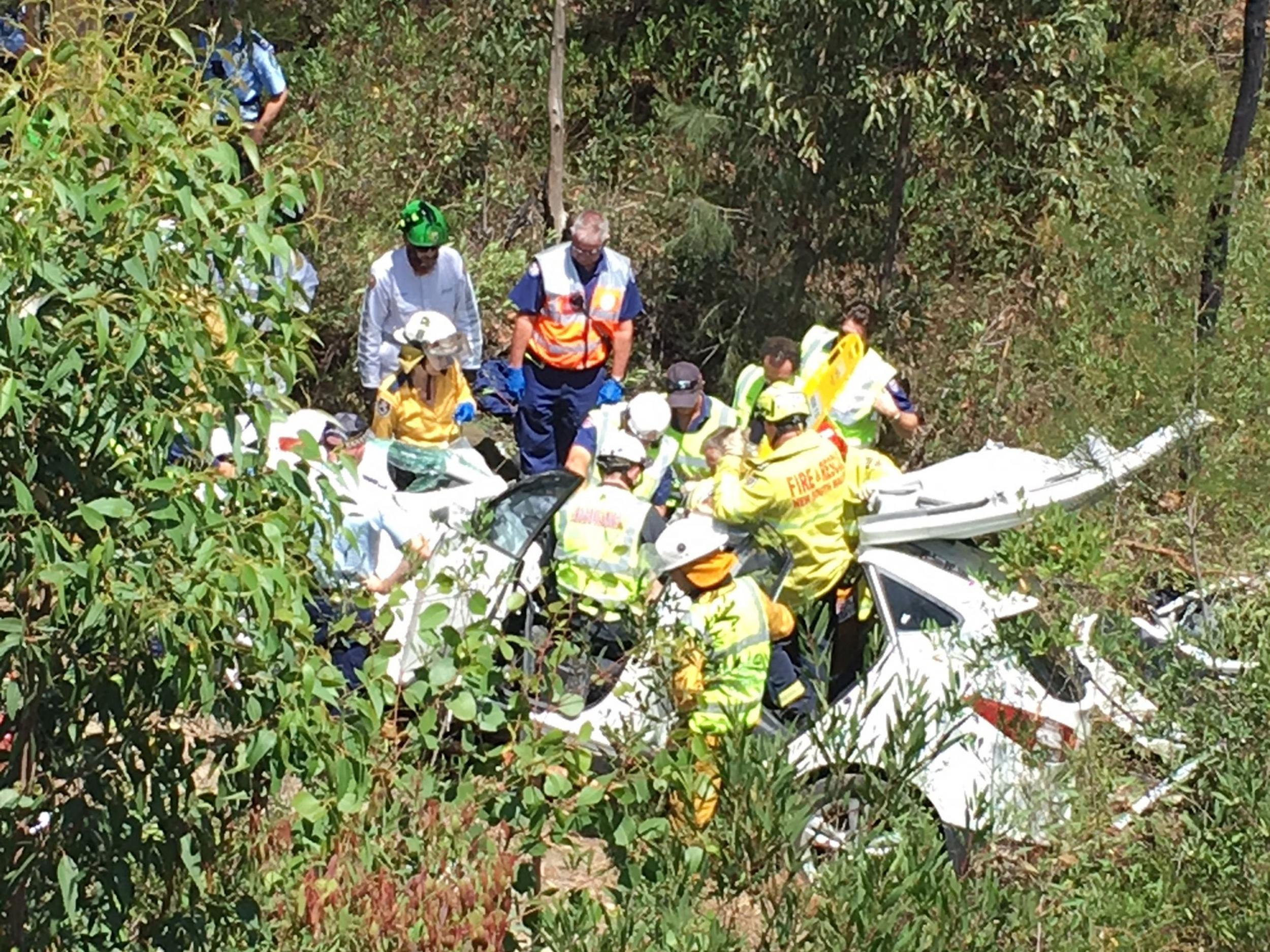 Emergency services work to cut Samuel Lethbridge from the wreck of his car