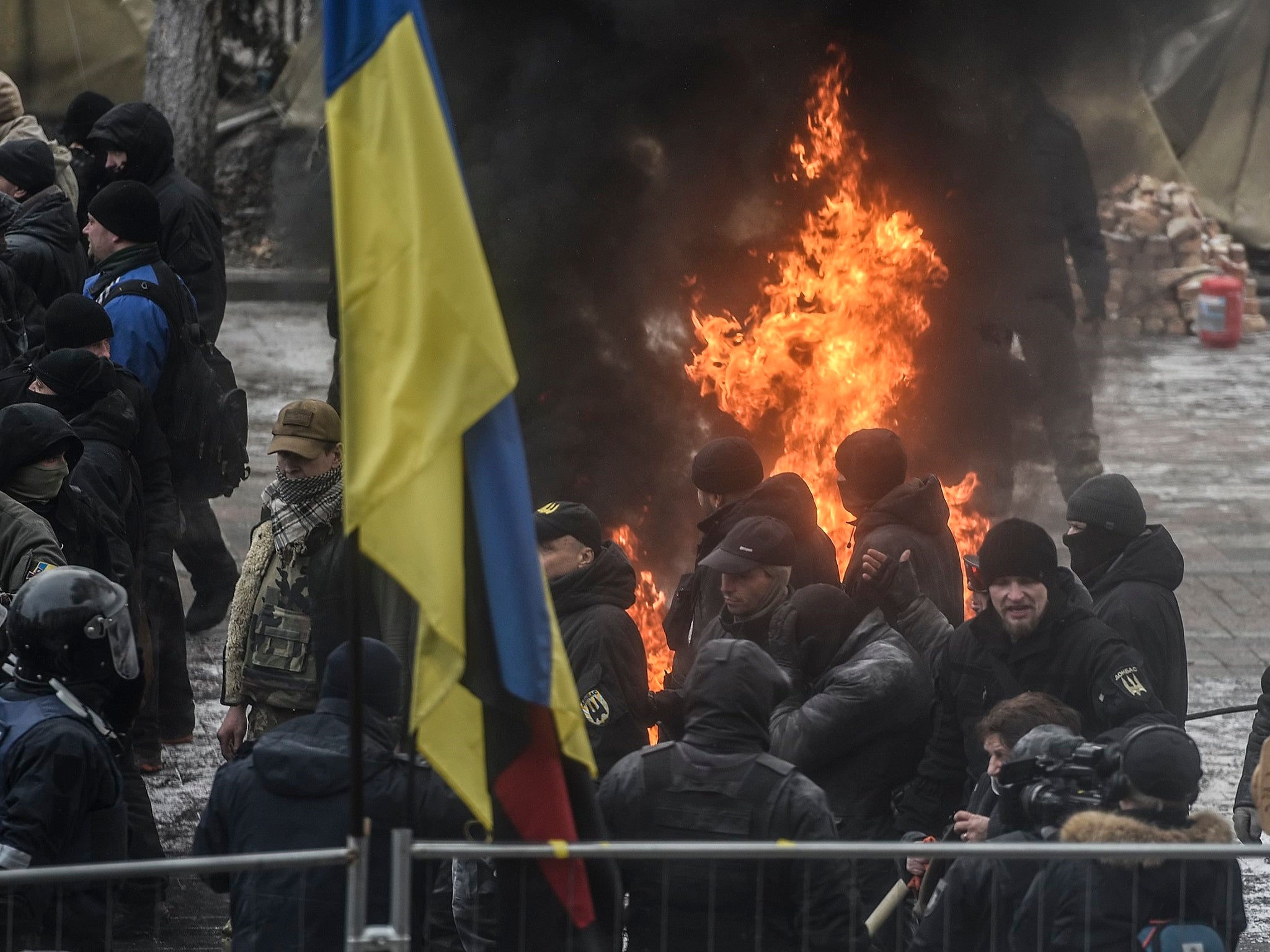 Protesters clash with police during their rally in front of the Parliament building in Kiev