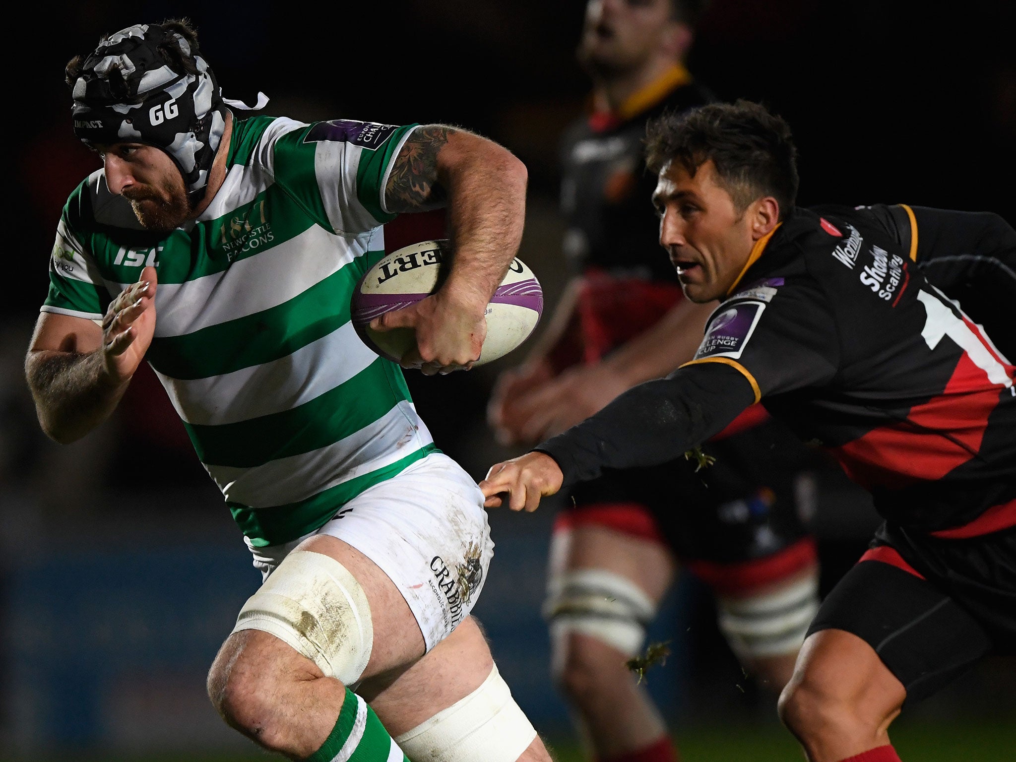 Gary Graham breaks free of a Gavin Henson tackle during a European Challenge Cup match between the Dragons and Newcastle Falcons