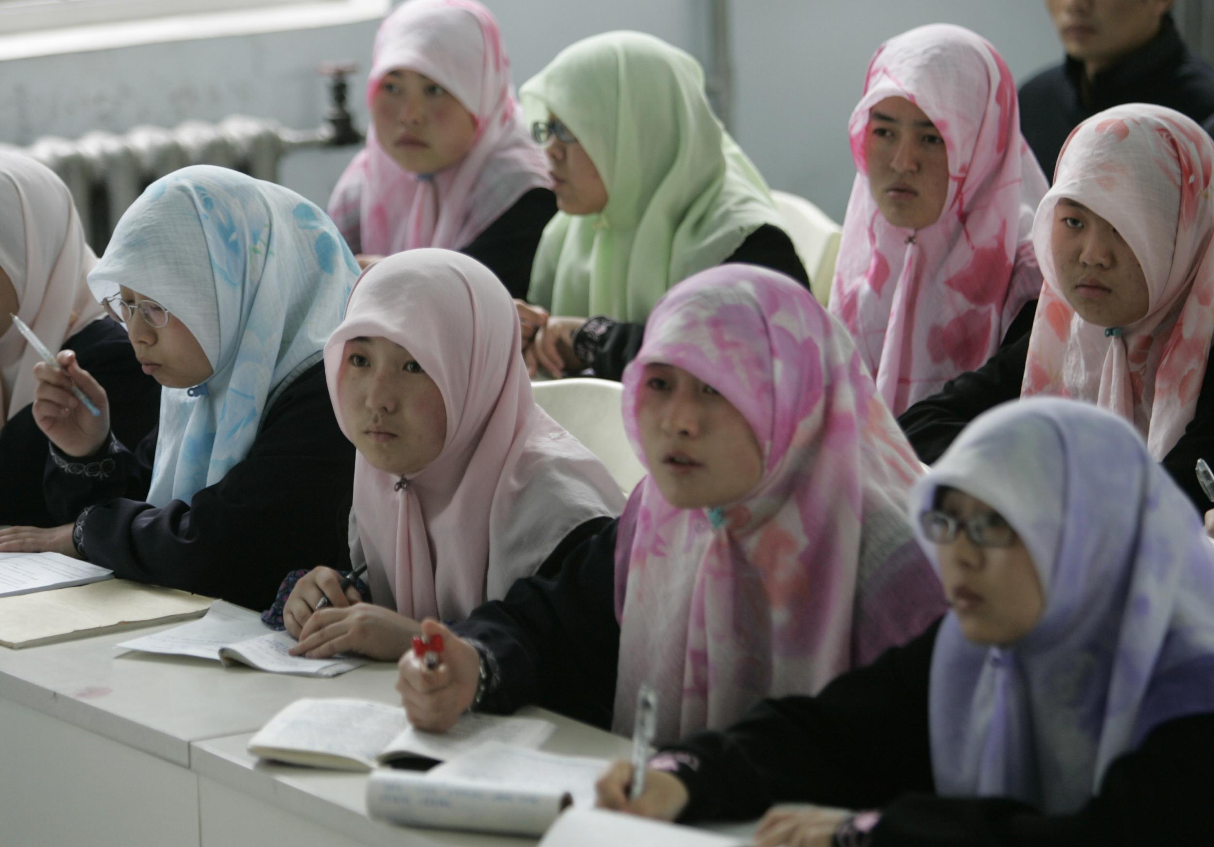 Muslim students from the Chinese Hui minority study in a class at Ningxia Islamic College in Yinchuan