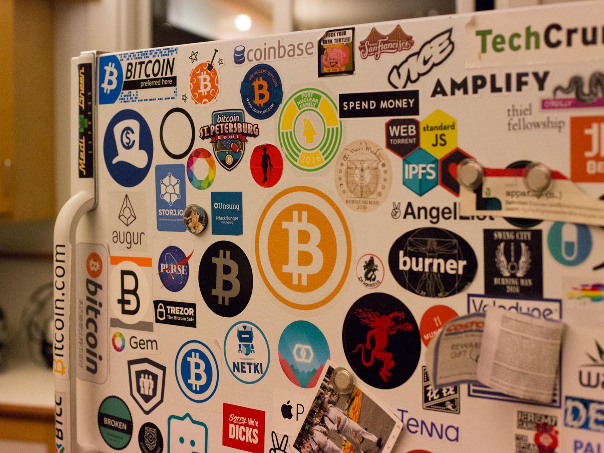 Stickers for various cryptocurrency-related companies plastered on a fridge in Gardner’s home