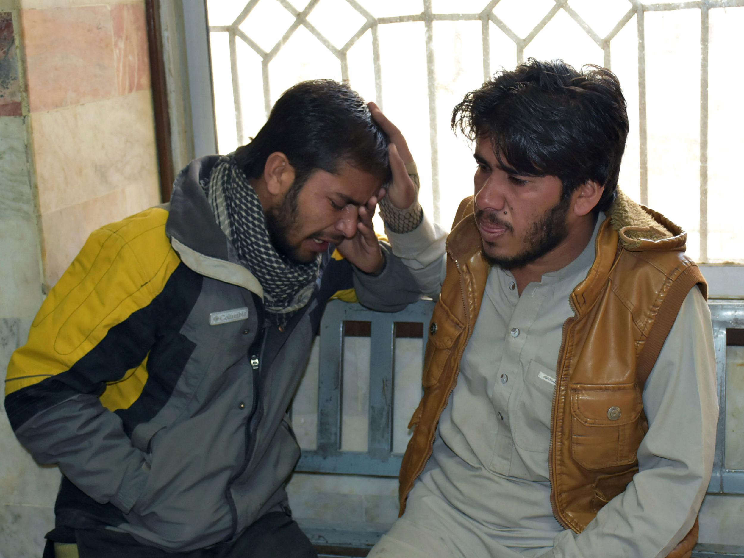 Relative mourn the death of a female anti-polio drive campaign worker who was shot by gunmen at a hospital in Quetta, Pakistan