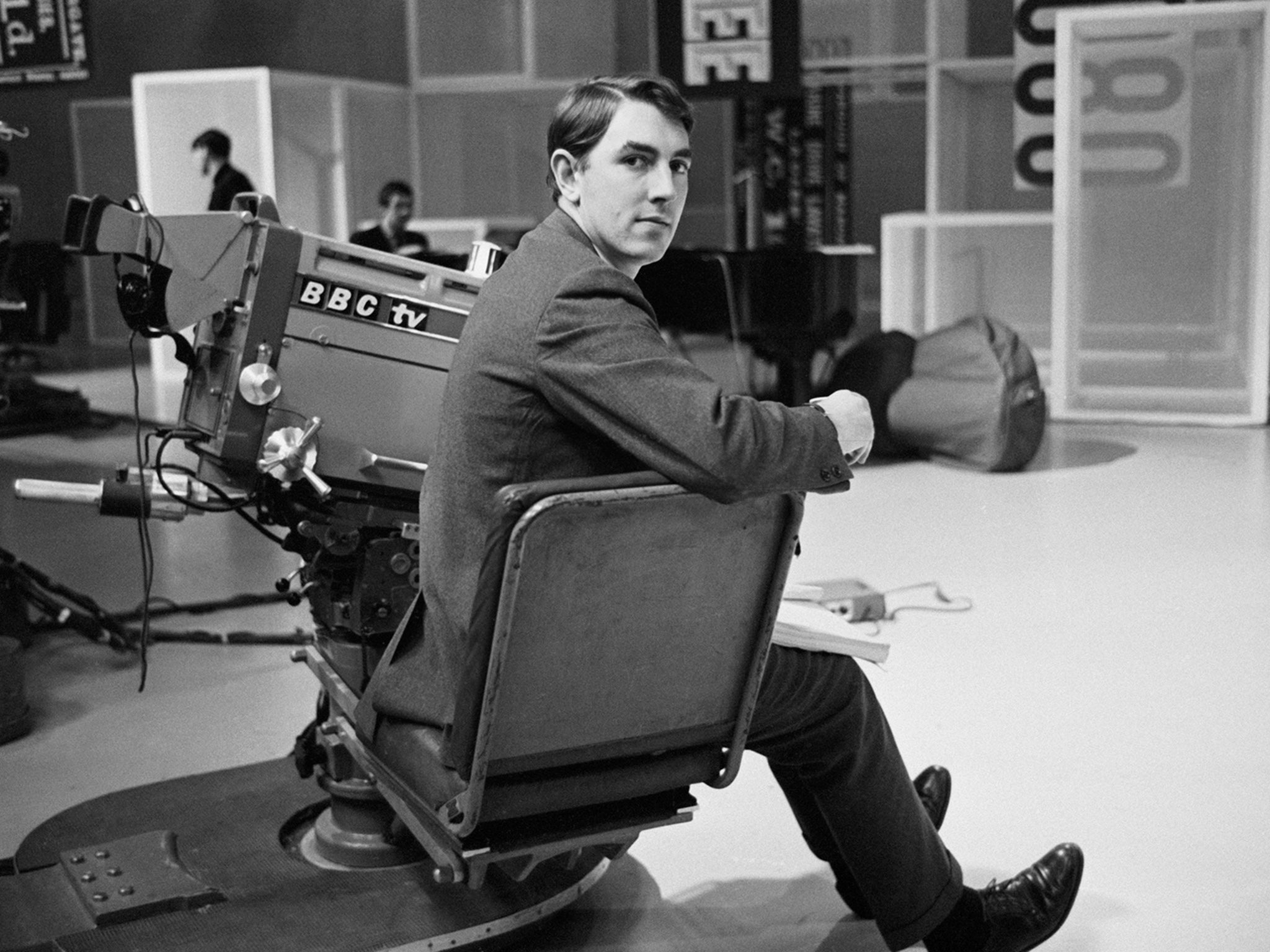 Peter Cook poses in a BBC studio in 1964 (Getty )