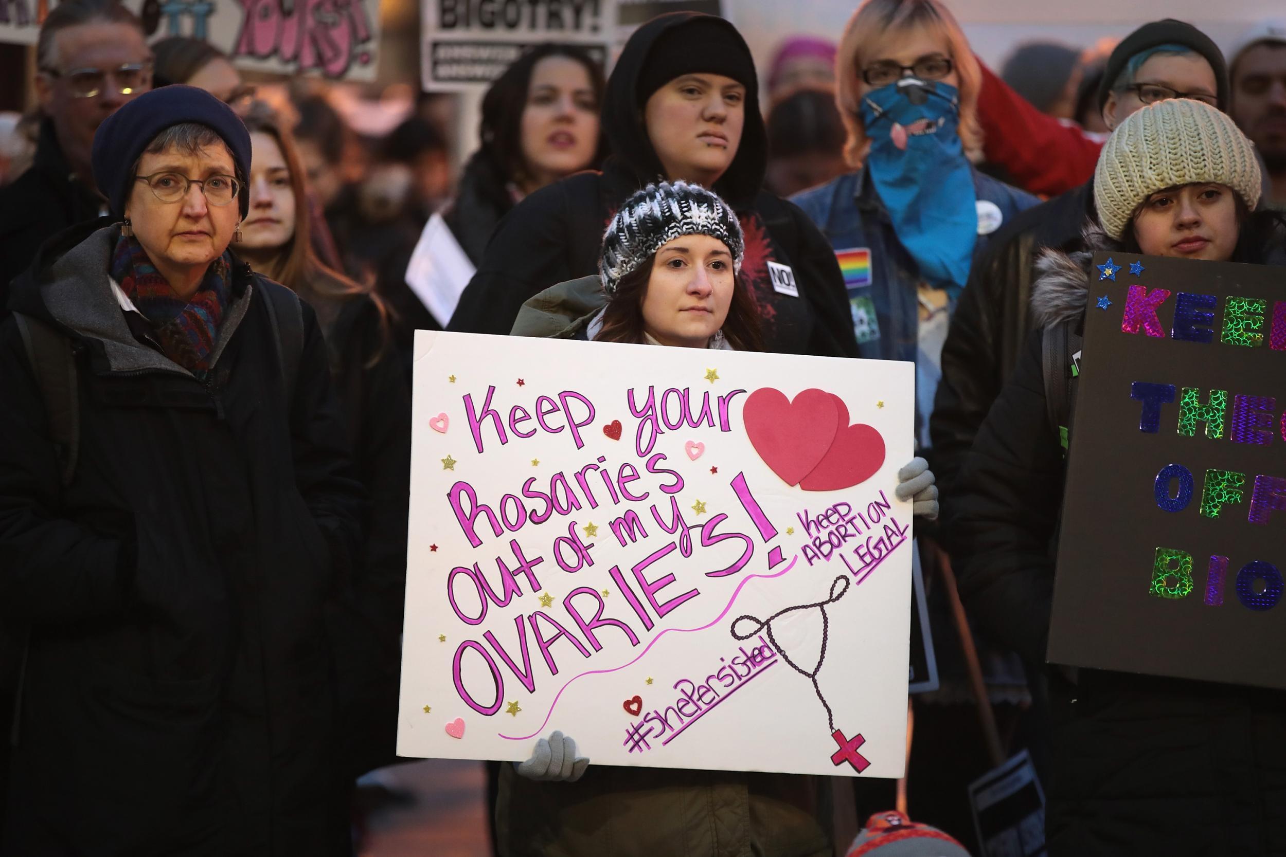 Demonstrators protest in front of the Thompson Center to voice their support for Planned Parenthood and reproductive rights