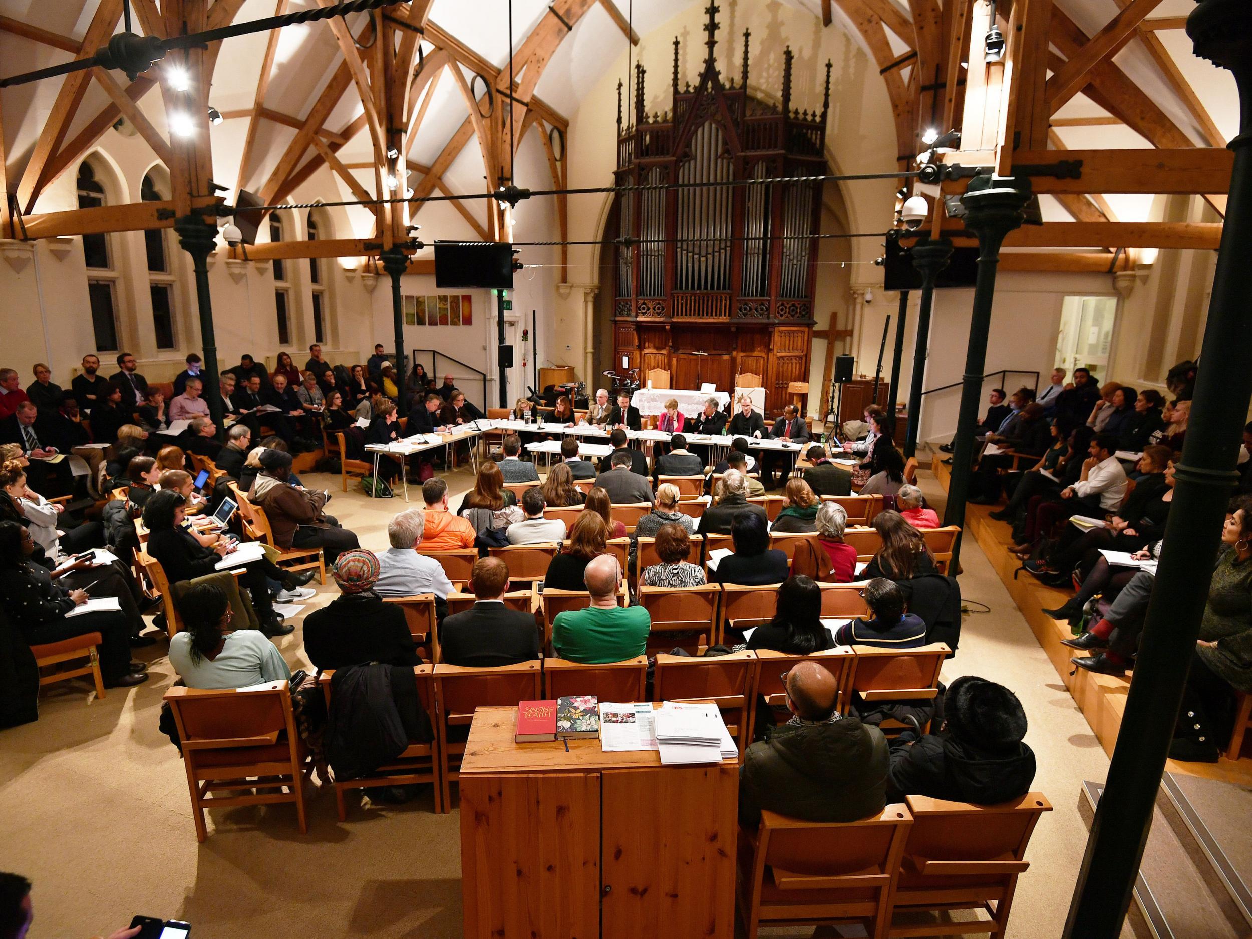 People attend the Grenfell Tower recovery scrutiny committee meeting at the Notting Hill Methodist Church