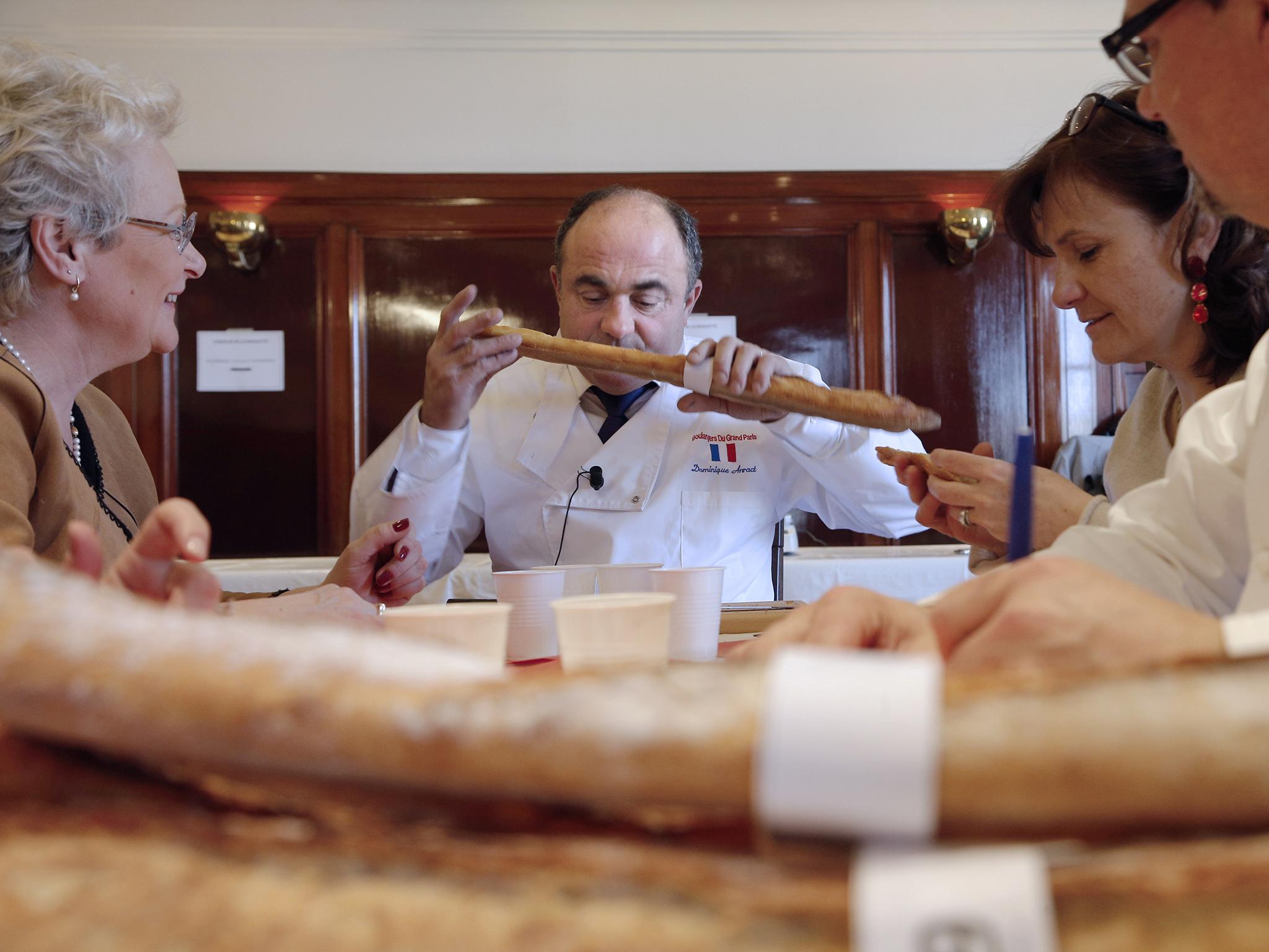 Dominique Anract (centre) testing baguettes during the 2016 French Grand Prize in Paris