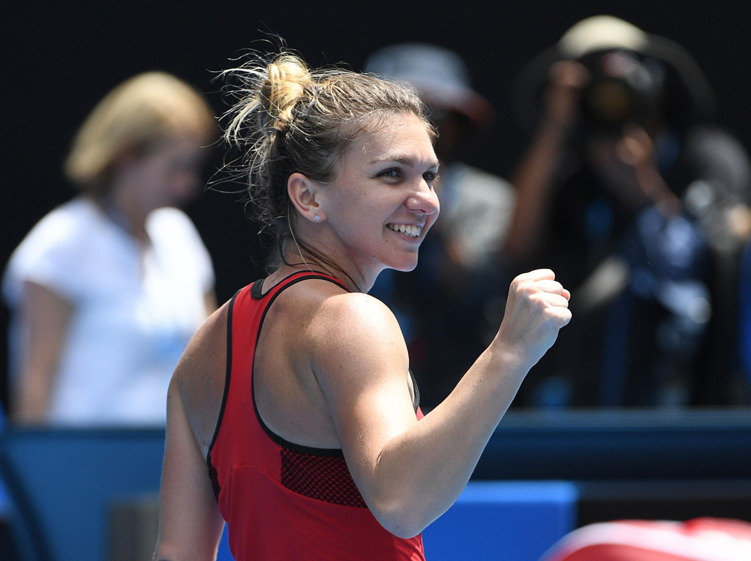 Simona Halep survived a marathon contest with Lauren Davis to advance