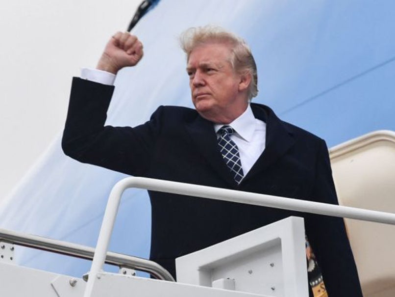 US President Donald Trump gestures as he boards Air Force One at Joint Base Andrews, Maryland on 12 January, 2018, for a weekend trip to Mar-a-Lago