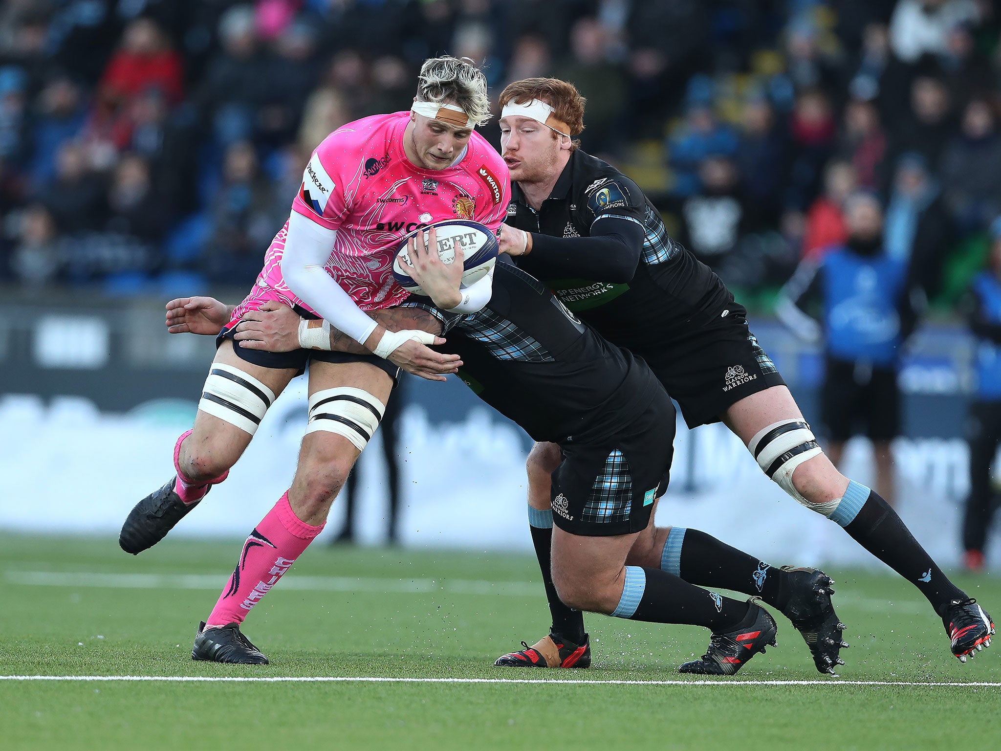 Jonny Hill tries to break free of a Jamie Bhatti tackle