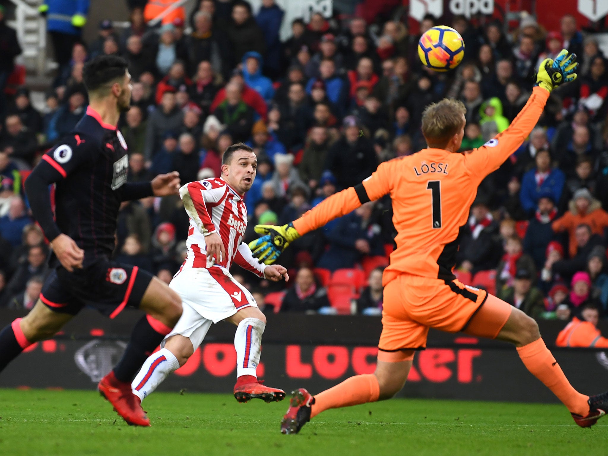 Xherdan Shaqiri attempts to lob Jonas Lossl