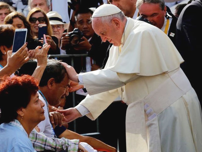 Pope Francis greets the faithful as he arrives to lead the Marian celebration of the Virgin de la Puerta in Trujillo, Peru