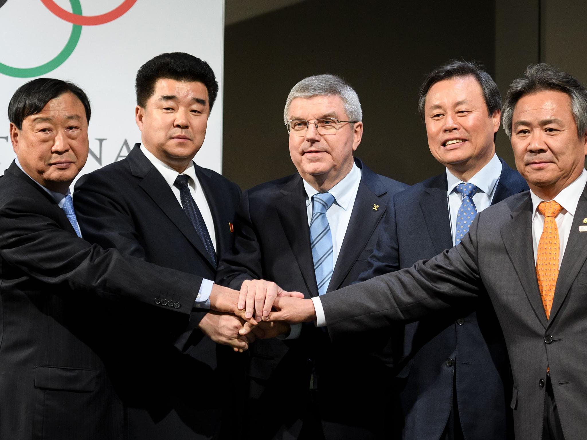 &#13;
Thomas Bach, president of the International Olympic Committee, centre, with representatives from North Korea, left, and South, in Lausanne AFP&#13;