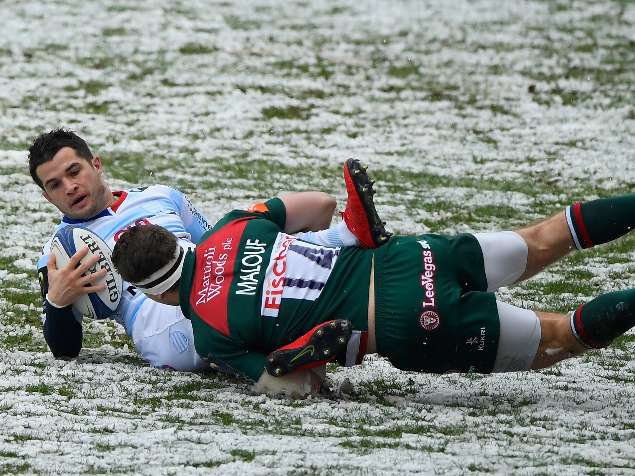 Brice Dulin is tackled into the snow by Nick Malouf