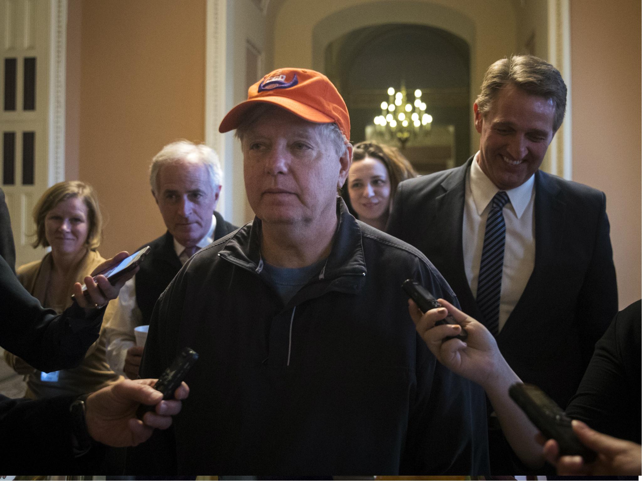 Senators Bob Corker, Lindsey Graham, Jeff Flake talk to reporters as they exit a meeting with Senate Majority Leader Mitch McConnell, 21 January 2018