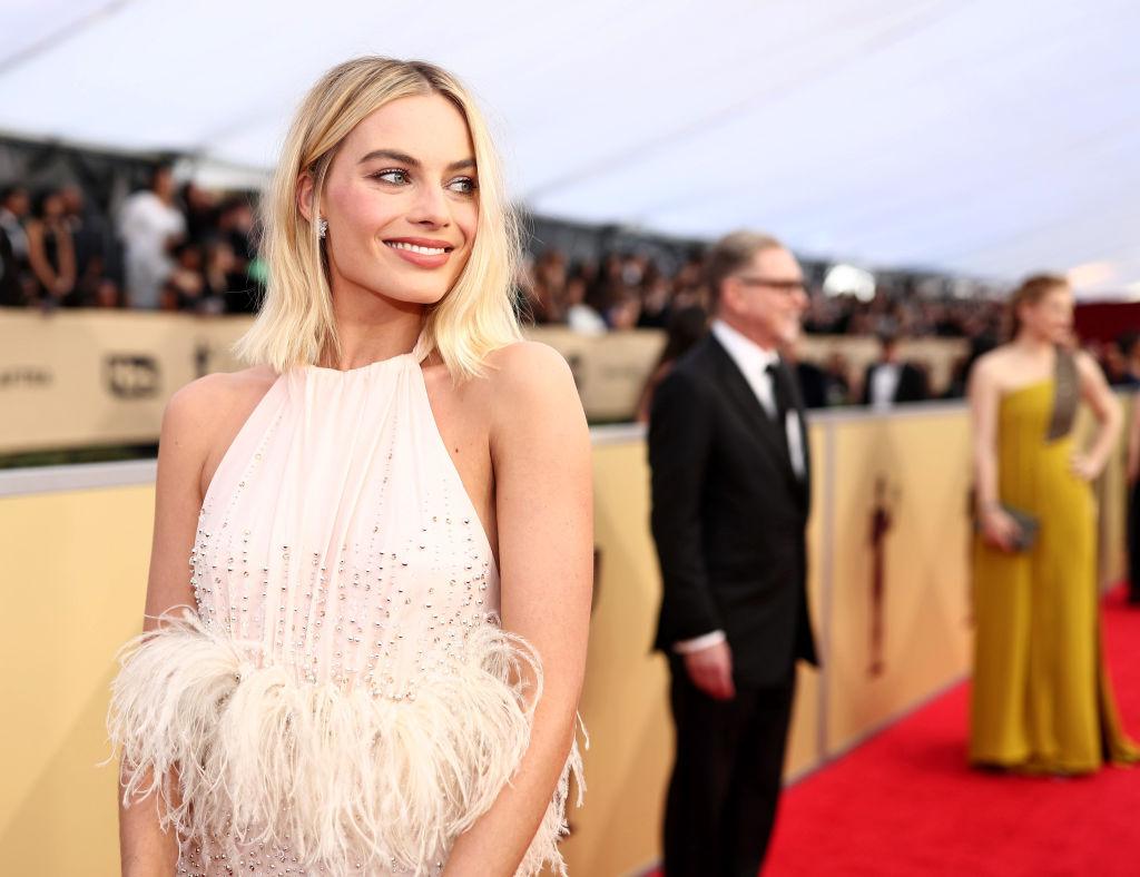 Margot Robbie wore a stunning powder pink Miu Miu gown, a shade which became the unofficial hue of the night