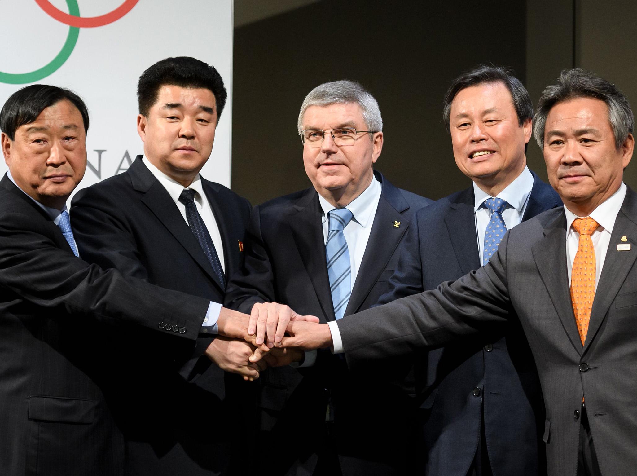 &#13;
Delegates from both countries join hands with the IOC president Thomas Bach (Getty)&#13;