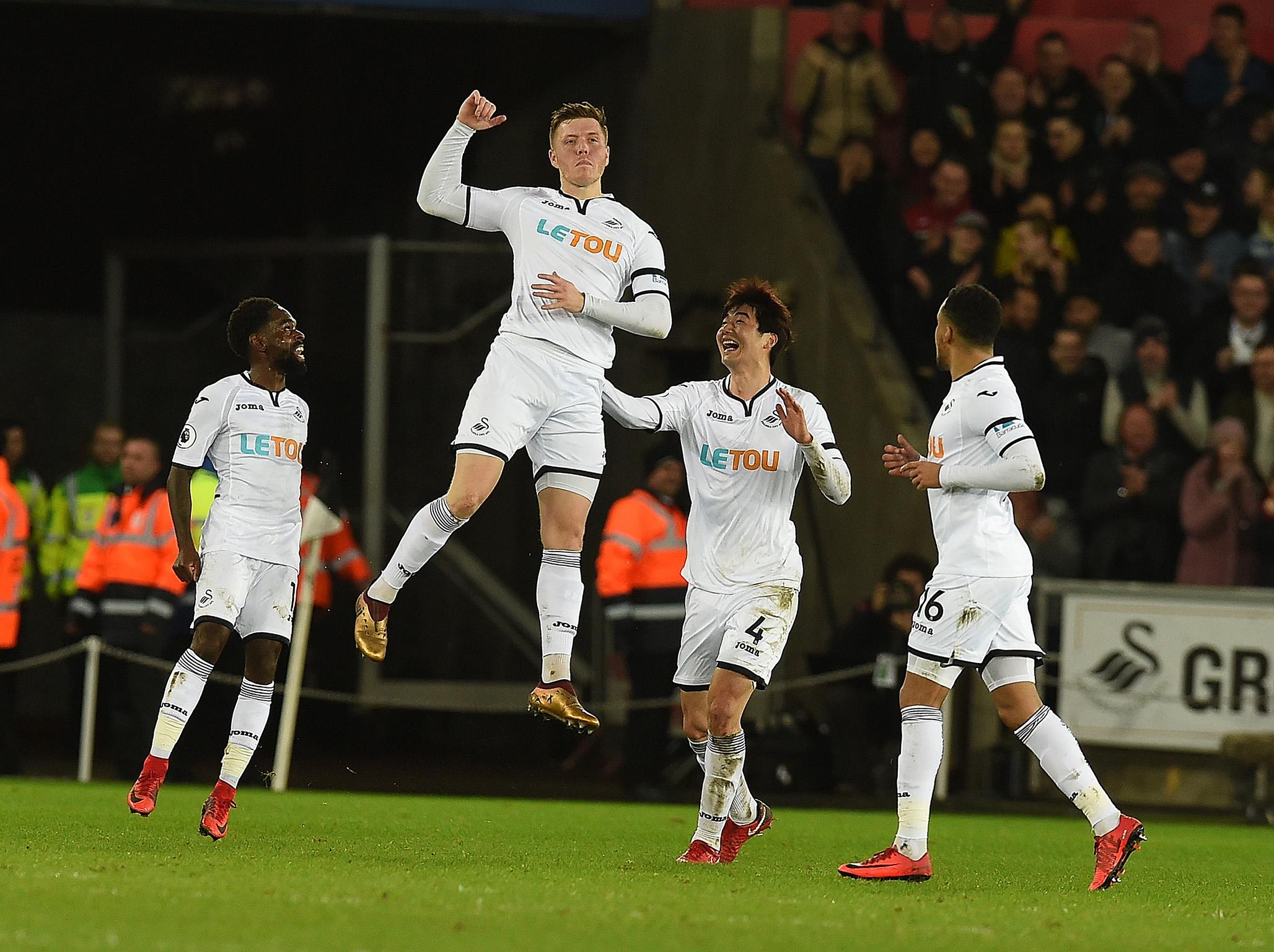 Alfie Mawson celebrates his winning strike