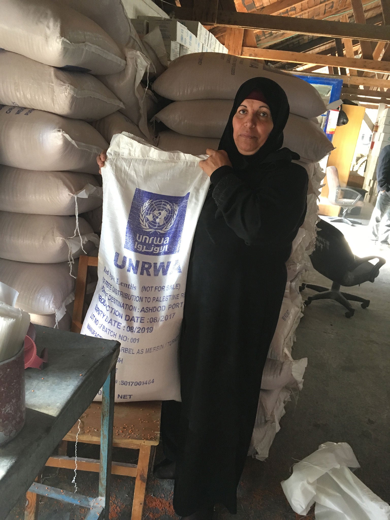 A refugee helper at the Beach Camp food aid centre on Monday