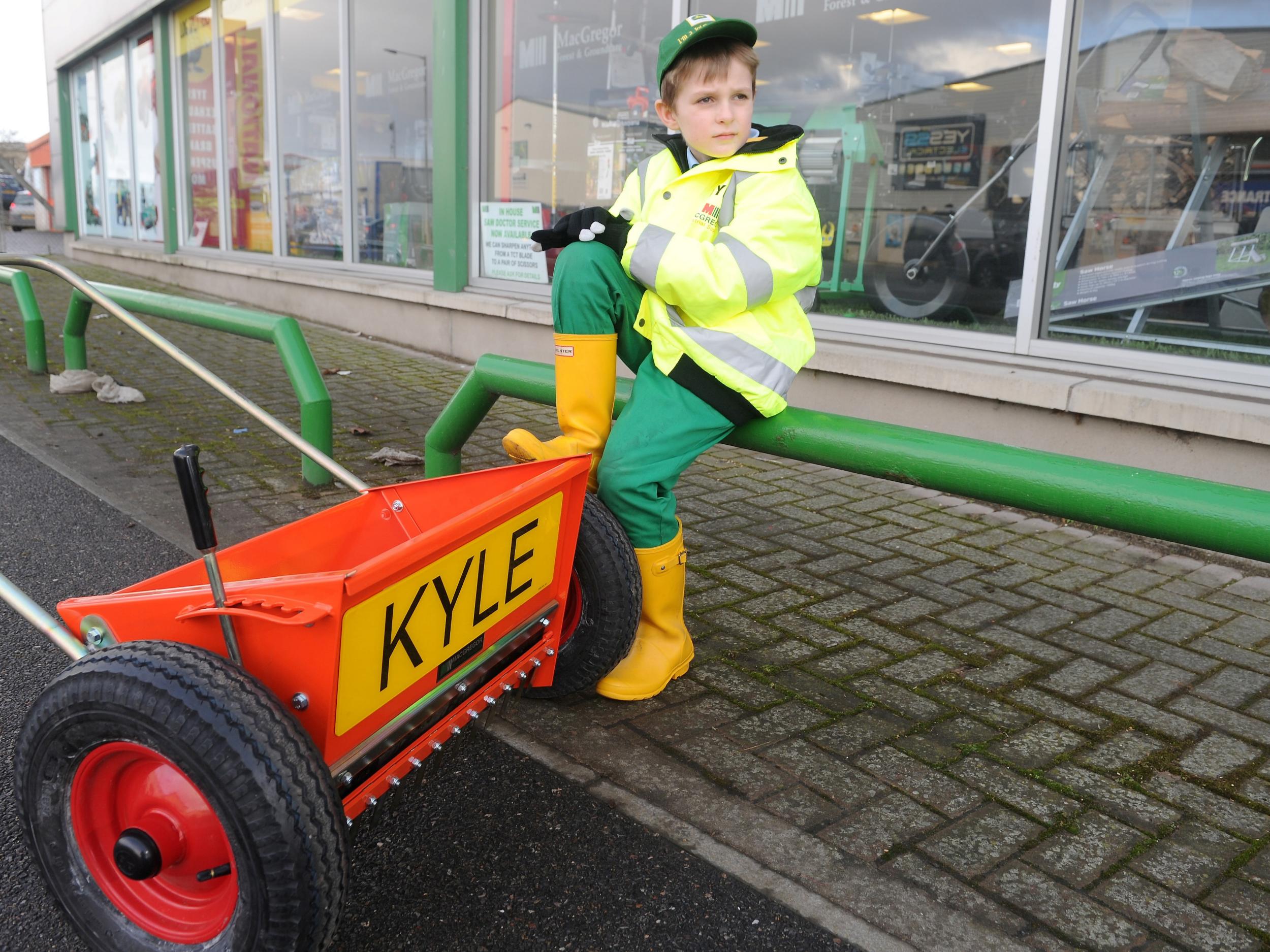 Kyle Mackay, eight, of Kiltarlity with his new grit spreader in Inverness