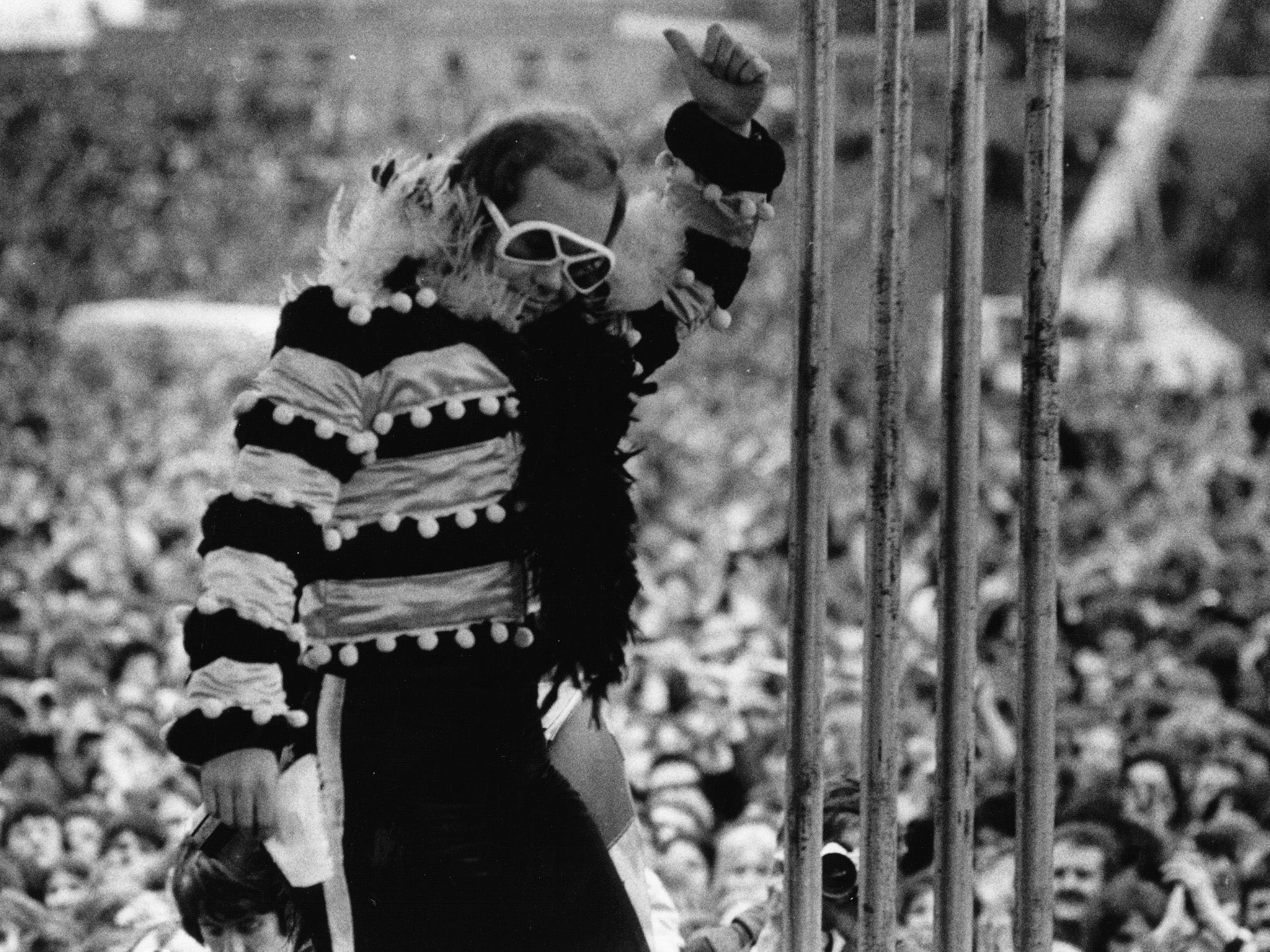 Elton John on stage at an open-air concert in 1974.