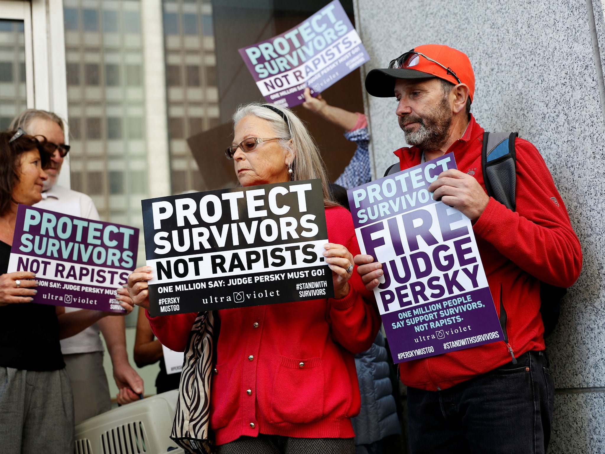 Activists hold signs calling for the removal of Judge Aaron Persky from the bench in San Francisco, California