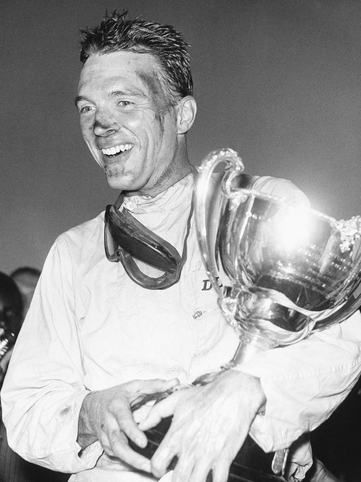 Dan Gurney holding a trophy in Nassau, Bahamas in 1962