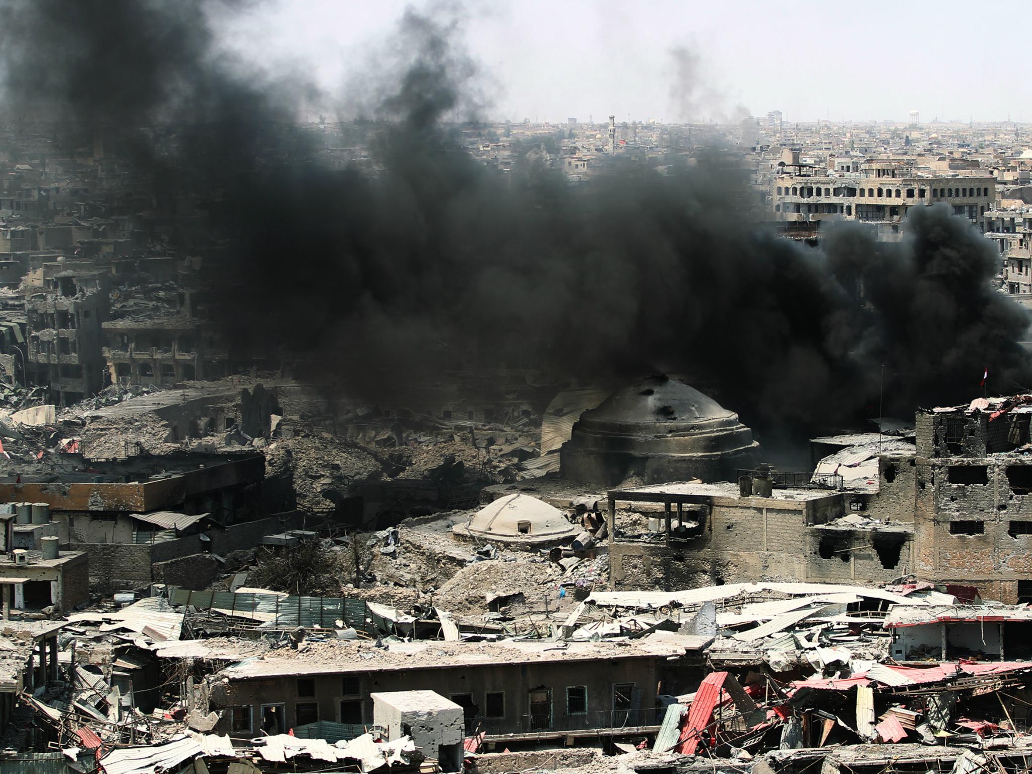 The women were arrested in Isis strongholds, including Mosul, where smoke is seen billowing here after a US airstrike last July before the city was re-captured from the militants